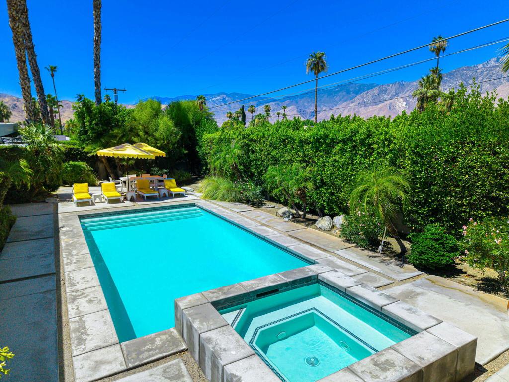 Mid-Century Modern inspired retreat with pool, spa, and timeless style. Welcome to your own Palm Springs oasis--this turnkey furnished, Mid-Century Modern designed home offers the perfect blend of style, comfort, and functionality. With 3 spacious bedrooms and 2 updated bathrooms, this 1,400 sq ft residence sits on a generous 10,019 sq ft lot and showcases warm, natural materials and clean architectural lines throughout. Step inside and you'll find wood-paneled and beamed ceilings, an open-concept kitchen with stainless steel appliances, and a cozy fireplace in the Family Room, creating a welcoming ambiance ideal for relaxing or entertaining. The seamless fusion of indoor and outdoor living is emphasized by sliding glass doors in all three bedrooms, opening directly to the expansive rear yard, large pool, and spa--perfect for soaking up the desert sun or enjoying cool evenings under the stars. Built in 2002 and sold fully turnkey, this home combines timeless appeal with modern convenience, offering enduring design and low-maintenance living. Best of all, there's no HOA, no land lease, and it's located just minutes from downtown Palm Springs, shopping, dining, and world-class entertainment. Whether you're looking for a proven short-term rental, a full-time residence, or a vacation getaway, this home is ready for you to move in and start living the desert lifestyle.
