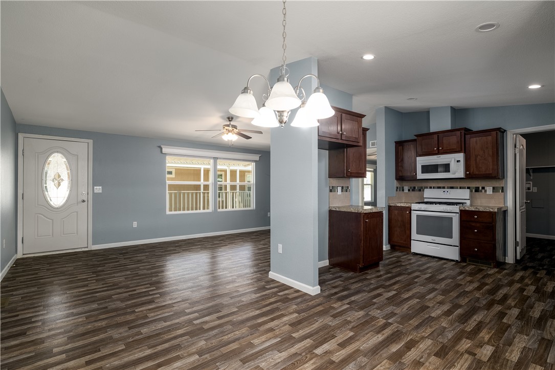 Welcome to 2205 W Acacia #15 in Villa Del Sol Mobile Home Estates!
This 2019 manufactured home offers 3 bedrooms 2 bathroom and a bright, open living area. The home features durable vinyl wood-style flooring throughout, ceiling fans in the living room and bedrooms, and an extra-large laundry room that gives you plenty of space. The covered carport is extra tall, perfect for a large truck and long enough to fit multiple cars. Located in the gated community of Villa Del Sol, this home is a great starter option with room to make it your own.