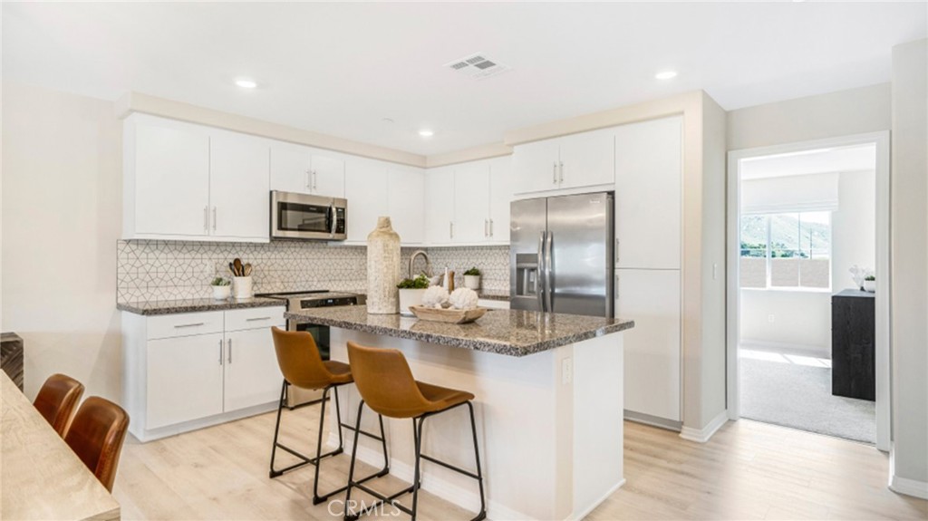 NEW CONSTRUCTION! Ready for Immediate Move-in! Includes Upgraded Flooring! This two-story home conveniently offers a two-bay garage and a sole secondary bedroom on the first floor with a full-sized bathroom, perfect for accommodating overnight guests. Upstairs, the kitchen, dining area and Great Room share an open layout for easy entertaining and hosting special gatherings. A luxe owner's suite is just off the shared living space and has an en-suite bathroom and walk-in closet.
The Paseo is a new collection of townhomes for sale coming soon to the Highgrove Town Center master-planned community in Highgrove, CA. Residents enjoy prime amenities within the community such as a social clubhouse, sparkling swimming pool, barbecue areas, tot lot and more. For local outdoor recreation, Box Springs Mountain Reserve Park features trails for hiking, mountain biking and horseback riding. Shopping and dining options at Downtown Riverside and the Mission Inn are just a 10-minute drive, while UCR is even less and nearby K-12 schools are a three-minute drive away.
