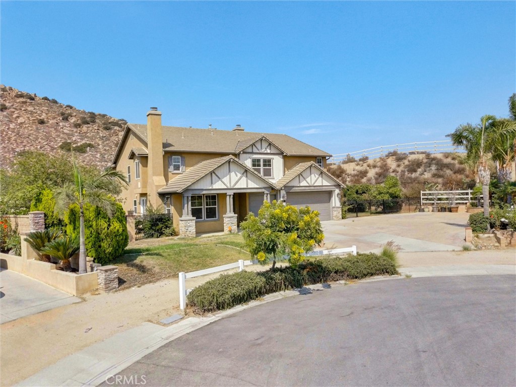 Prime Norco Hills 5 Bedroom, 4-1/2 Bathroom Home at the end of a Cul de Sac in a great Neighborhood. Picture perfect Curb Appeal, with a Four-Car Tandem Garage, and room to park an RV and multiple Vehicles. This substantial Property is on .75 acres, with plenty of room to make all your dreams come true. As you enter the Front Door, Vaulted Ceilings set the tone for bright and spacious Rooms with lots of Windows. Formal Living Room with a Fireplace - one of three in this home - and a formal Dining Room lead to the open Kitchen with abundant Cabinet Space, a huge Island, a Butler's Pantry, a Walk-in Pantry and Breakfast Nook. The Kitchen opens to a large, cheerful Family Room with a cozy Fireplace, and custom Built-in Cabinets. Beyond the Family Room is an Office Space, with an ensuite full Bathroom, which could be modified to make a 5th Bedroom. A Powder Room and Laundry Room complete the First Floor. Upstairs you will find a grand Primary Suite, with an expansive Sitting Room and another Fireplace. Two Walk-in Closets, a sizable ensuite Bathroom with a jetted Soaking Tub and dual Sinks, including a built-in Vanity, complement the space. A roomy Loft, which opens to the main upstairs Hall, and three additional oversized Bedrooms, are also on the Second Floor. Two of the Bedrooms share a Jack and Jill Bathroom, both with Ceiling Fans and Mirrored Closets. One of the rooms also has an Alcove, perfect for a Workstation or Reading Nook. The fourth Bedroom, with its own ensuite Bathroom, also connects to the Loft, which could easily function as a second Primary Suite, or a fun Playroom. This Home has so much to offer including multiple Fruit Trees - avocado, orange, tangerine, guava and more! With a desirable Location, a huge Lot, large-scale Rooms and a perfect Floorplan, the possibilities are endless. Come check out this great Property!