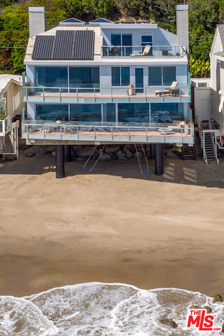 Elegance and modern comforts unite in this sun-filled 3-story immaculate turnkey home w/apx. 50ft of beach frontage & dramatic views of Point Dume Beach, the Queen's Necklace & Catalina Island. Attention to quality & detail was created throughout, from the custom glass doors, vaulted wood ceilings, radiant heated wood floors & ocean views from nearly every room. Enter through the airy courtyard into the main level, past a custom designed aquarium and tide pool to a floor-to-ceiling glass great room that includes formal sitting/dining area & gourmet kitchen w/Italian Boffi cabinetry, plus a beautifully designed den, all flowing out to a huge entertainer's balcony. Continue up the 3-story "floating" stairs to the 2nd level ocean view owner's suite w/balcony & ocean view spa-bath & steam shower w/huge closet. The rare 3rd level offers an ensuite bedroom & large viewing deck. 2-car garage w/guest parking, steps to the beach & more makes this guard gated gem the ultimate in beach living.