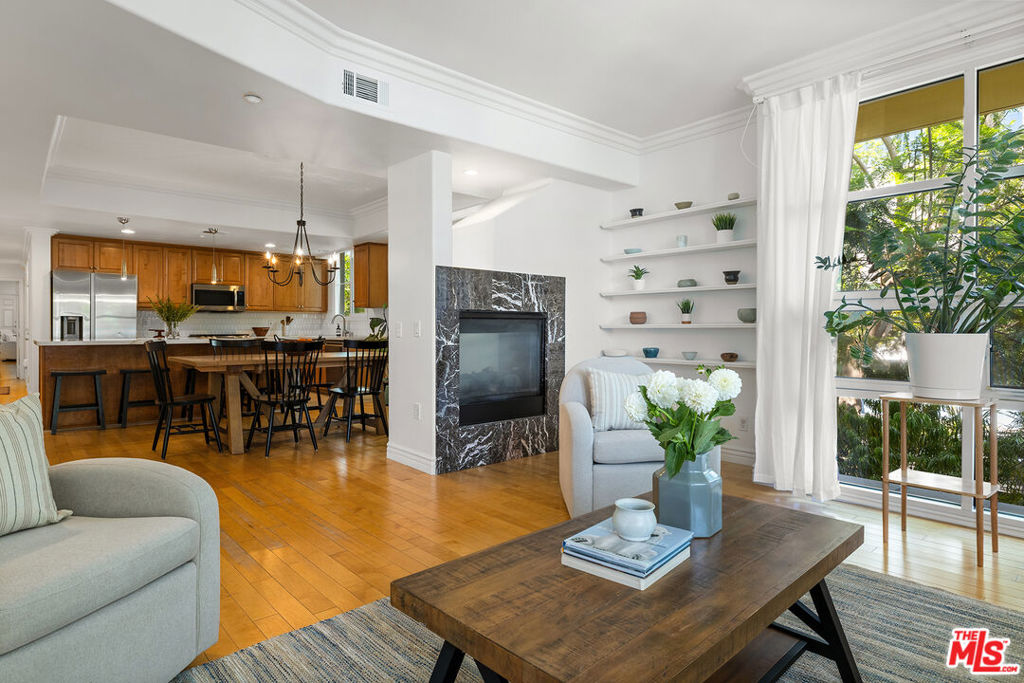An unparalleled experience on the Westside: this expansive 4-bedroom, 4.5-bathroom residence features floor to ceiling windows, new appliances, and a luxurious master suite. Spanning the entire northern half of the second floor plus a private second level, the home checks all the boxes: scale, layout, privacy, and location. Designed for modern living and effortless entertaining with an open floor plan and upgraded features like a dual-sided fireplace, coffered ceilings, and a chef's kitchen with huge island. Thoughtfully updated with new windows, custom kitchen with upgraded appliances, new HVAC, custom closets, renovated spa like master bath, and more. The main level features an expansive living room bathed in natural light from the custom floor to ceiling windows - opening into a dining room and open concept kitchen. Two en-suite bedrooms, including a spacious primary suite with soaking tub and private balcony. Downstairs, you will find two additional ensuite bedrooms, a laundry area, and custom storage closet providing flexibility for guests, home office, or multigenerational living. Additional highlights include direct-access secured elevator with personalized controls (serving only two residences per floor) and two gated garage parking with guest spots. Set in one of LA's most desirable neighborhoods, minutes from UCLA, Westfield Century City, Santa Monica, Brentwood, Beverly Hills, Silicon Beach tech hubs, LAX, and a world-class selection of dining and shopping options - while walking distance. You won't find another property like this on the west side at this price point.