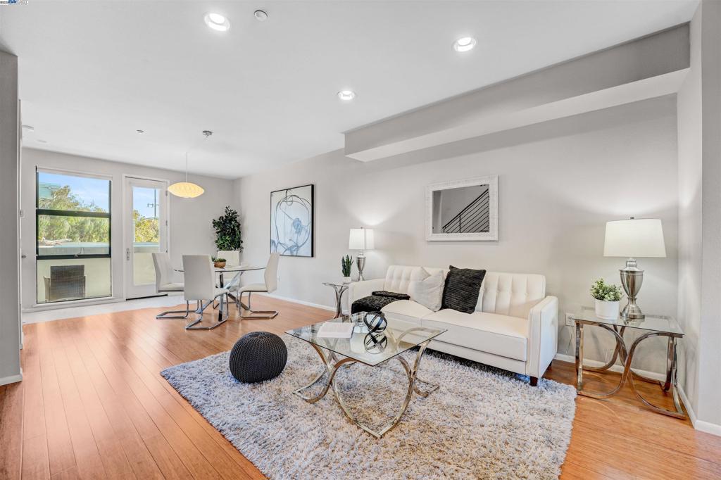 Industrial edge meets everyday comfort at 1220 66th St, a 2 bed, 2.5 bath, 1466 sqft townhouse-style condo with personality from the start. Walk in through the front door or garage and you’re greeted by a flex space begging to be customized. Gym, art studio, office, or the kind of lounge you never want to leave, this space is all about options. The second floor brings the wow factor with bamboo floors, exposed brick, cement accents, and a bold wood-and-metal staircase. The open kitchen flows into a dining and living area filled with natural light, while a half bath and private deck keep things practical and social. Morning coffee, evening wine, or mid-day snacks, this level was built for it all. Upstairs, two ensuite bedrooms deliver privacy and style, while in-unit laundry saves you the laundromat hustle. Fresh paint keeps it crisp, a two-car garage with EV charging makes it future-ready, and a 90 Walk Score puts you steps from Aquatic Park, BART, Berkeley Bowl, coffee, restaurants, and easy freeway access. Trendy, versatile, and totally Emeryville.