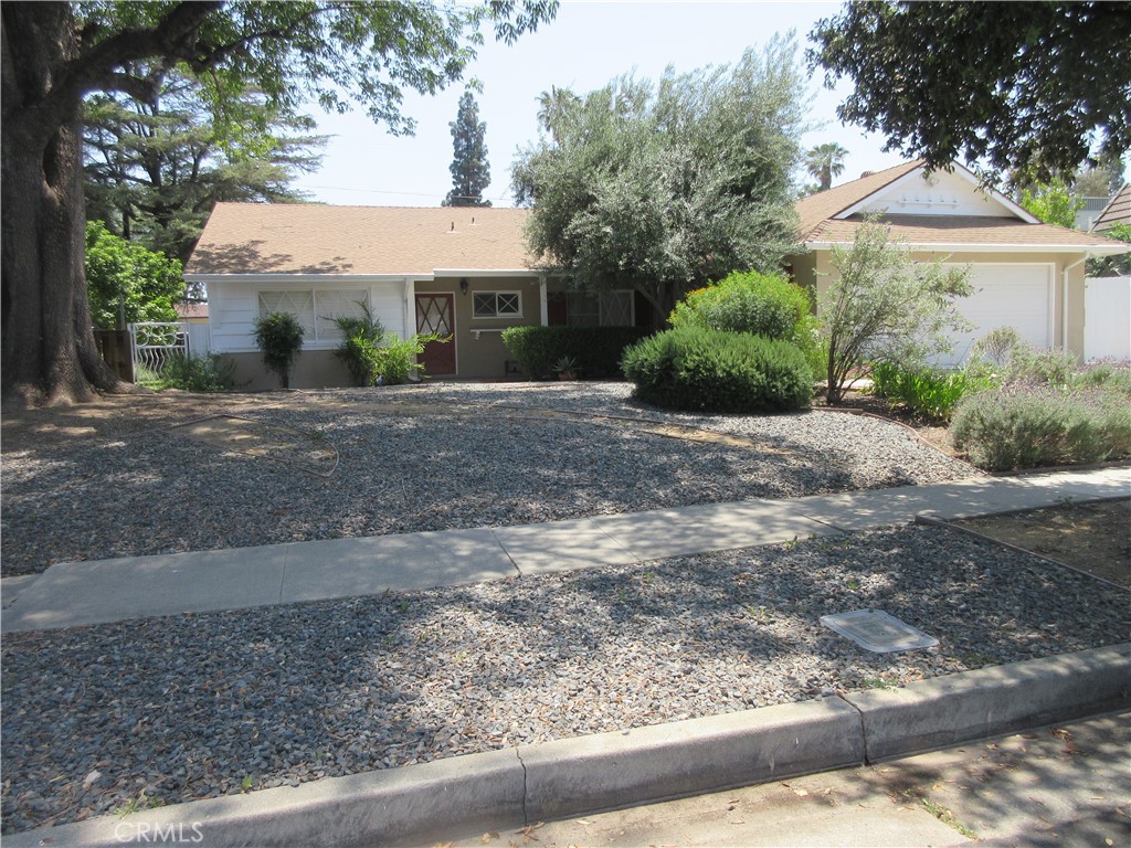 This gorgeous 3-bedroom 3-bath house has 2 bedrooms with an en-suite bathroom. Newly painted inside, with a mix of tile and new carpet flooring. Gorgeous kitchen with stainless steel stove, built-in microwave, granite countertops, and handy breakfast bar that opens to the adjacent family room. Includes a brick fireplace and a sliding glass door to bring lots of light inside with easy access to the backyard. The laundry room is located in its own room off the kitchen with extra storage. Low-maintenance landscaped front yard. The backyard is landscaped with plants, flowers, and a large grassy yard with a beautiful covered patio. Bonus, there is an area for a small RV or Boat parking off the back alley. NO PETS preferred. Central air, 2-car garage. Ready to go with REDUCED PRICE.