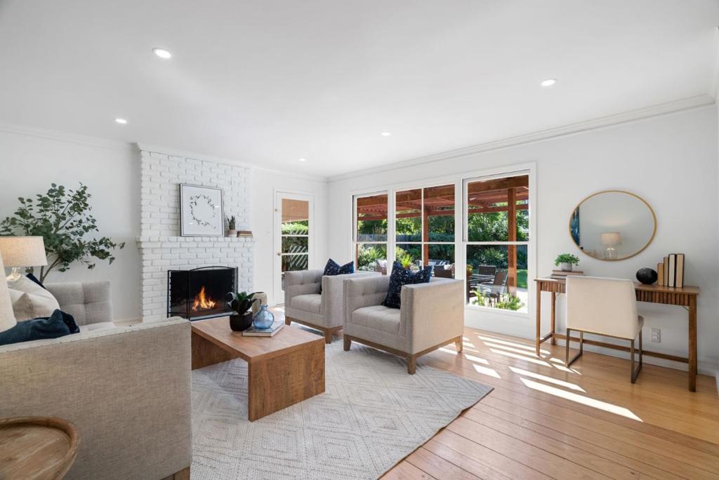 Set on a generous 10,125-square-foot lot, this inviting three-bedroom, two-bathroom Los Altos residence blends comfort, natural light, and thoughtful updates. Set back from the street and surrounded by lush green trees and bushes this single-level floor plan is enhanced by hardwood floors throughout, freshly painted interiors and exterior, and recessed lighting that creates a bright, welcoming atmosphere. Outdoors, the sun-drenched backyard provides a versatile canvas for living whether enjoying a quiet afternoon on the shaded patio nook, gathering for games on the open lawn, or cultivating citrus and fruit trees in the garden. The rear yard is currently accented by fig, orange, apple, plum and even a pumelo tree. The living and dining rooms extend effortlessly toward the outdoors, where a wall of windows captures leafy views of the expansive backyard. With its warm character, versatile layout, and sun-drenched outdoor spaces, this residence offers an exceptional opportunity to enjoy Los Altos living at its best. Discover the perfect balance of comfort and style. Just moments away are parks, shopping conveniences, El Camino Hospital, as well as Oak Elementary, Blach Middle and Mountain View High School (Buyer to verify attendance).