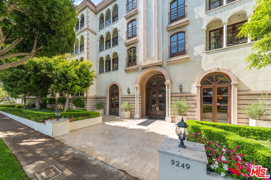 In the heart of Beverly Hills, La Faubourg St. Germaine, a French Normandy-style concierge building, showcases its timeless character and impressive two-story grand lobby, conveniently located next to the renowned L'Ermitage hotel. Residence 302, a rarely available front-facing condo, features the building's largest 1,963 sq ft floor plan, masterfully blending scale, privacy, and thoughtful design. A formal entryway leads to a sun-filled living room, complete with French doors, two Juliet balconies, custom moldings, and a refined fireplace, creating an atmosphere of sophistication and comfort. The chef's kitchen boasts new stainless steel appliances and granite countertops, paired with brand-new hardwood floors throughout. Two primary suites are strategically positioned on opposite wings, each featuring a private balcony and walk-in closet, offering the perfect balance of luxury and seclusion. Amenities include a concierge on-site Monday through Friday, two elevators, a gym, side-by-side oversized parking, a dedicated guest parking area, and substantial individual storage. Updated security cameras provide enhanced peace of mind, while the rooftop deck offers panoramic views of Beverly Hills, Hollywood Hills, and Century City.
