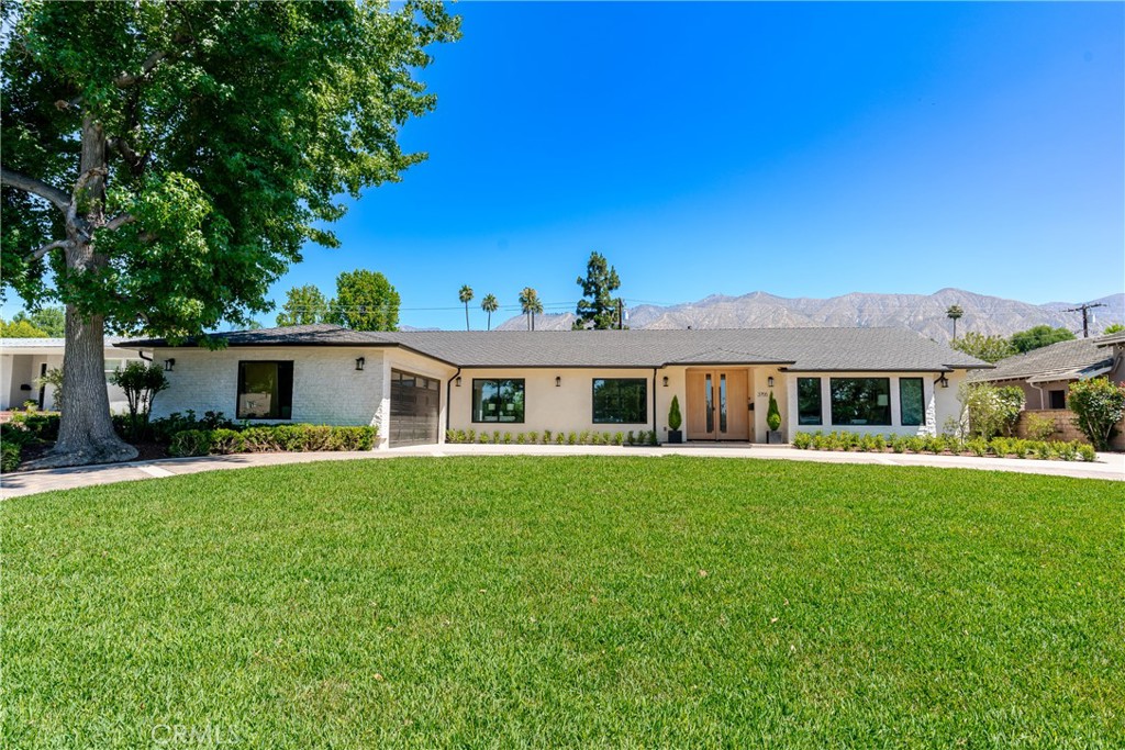 Welcome to this beautifully renovated single-level modern ranch home, ideally located on a spacious, flat lot in the highly sought-after Lower Hastings Ranch neighborhood of Pasadena. The main residence spans approximately 3,644 square feet, offering 4 generously sized bedrooms and 4 stylishly appointed bathrooms. A detached 737 square foot ADU provides excellent flexibility for extended family, guests, or rental use. Inside, a light-filled, open floor plan unfolds with a dramatic great room, formal dining area, and a quiet home office, all under soaring ceilings that enhance the sense of space. The gourmet kitchen features top-of-the-line designer appliances, custom fixtures, and a hidden walk-in pantry that adds both functionality and charm. Thoughtful details include new wide-plank hardwood floors, custom cabinetry and closets, and dual wine and beverage refrigerators. Two expansive covered patios extend the living space outdoors—perfect for entertaining or relaxing on warm summer days. The backyard is finished with nearly 3,000 square feet of low-maintenance artificial turf, creating a lush and inviting retreat. Curb appeal is elevated by a new driveway and a striking double 42-inch entry door, completing the home’s modern elegance.