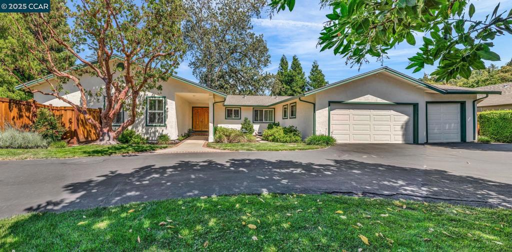 Beautifully Updated Single-Level Home in Prime South Walnut Creek Location. Nestled on a flat ~1/3 acre lot, this stylishly updated home offers modern comfort and an ideal layout. The open-concept kitchen features a 4-burner gas range with griddle, center island with bar seating, and views into the cozy family room with brick fireplace and slider to the lush backyard. A spacious formal dining area opens to the extra large living room, ideal for entertaining, reading, or watching the perfect show, and includes a second slider to the patio, and backyard. Plenty of parking for the owner, and guests on the large circular driveway, and attached 3 car garage, The light-filled primary suite includes a generous walk-in closet, updated bath with oversized tile shower, dual sinks, and a private heat sauna. Additional features include recessed lighting, plantation shutters, and rich wood flooring throughout, with plush carpet in the primary bedroom. Enjoy a park-like backyard with expansive lawn, mature landscaping, and space for a pool, play area, or ADU. Detached storage shed and flagpole add utility and charm. Just minutes to downtown Walnut Creek, the core shops and restaurants, and the highly coveted top-rated WC schools, freeway access, Iron Horse Trail, and Rudgear Park.