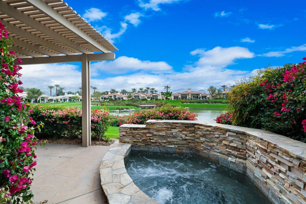 South Lake Views + Private Spa! CLUB Membership available to Buyer - no wait. This lakefront Acacia 4 condo has a covered patio with private spa, and expansive mountain and course views of #7 Grove. Offered Furnished per Inventory, this 3 bedroom/3.5 bathroom Indian Ridge CC condo is beautifully maintained! The Living room opens out to the patio and spa area, and is accented with crisp white shutters, built-ins, fireplace and wet bar. Fabulous views also from the kitchen and breakfast nook, which open to the patio with builtin BBQ, and features stainless appliances and island. The separate dining room is adjacent to the living room - ideal for ease of entertaining. Primary suite has a private patio area, bath with tub & shower, double vanities, and a generous walk in closet. Both guest bedrooms are en suite - the front guest suite is currently used as a den. The attached 2-car garage has direct access in to the house via the laundry room. Great location - just a few houses away from two of the many community pools & spas, and around the corner from ''Rover's Ridge'' dog park. HOA monthly dues include security, cable & internet, all gardening, exterior paint, roof maintenance, exterior water, exterior pest control and trash. Indian Ridge CC features two Arnold Palmer Signature golf courses, tennis/ pickleball facilities, a fitness center, a full-service spa, two restaurants, 38 community pools/spas & active social calendar. Come Join the Fun!
