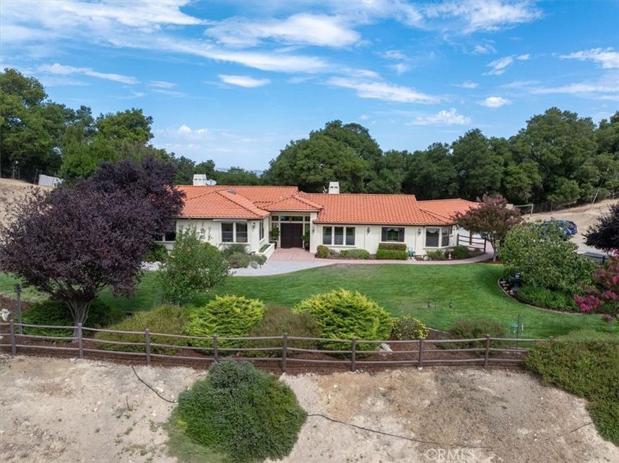 Welcome to 2955 San Fernando Rd, a custom single-level home on 3.8 fully fenced acres in West Atascadero. Enjoy sweeping hill, valley, and city-light views from the 2,800+ sq ft home featuring 4 bedrooms, 2.5 baths, and a 3-car garage. The spacious living and family rooms share a double-sided fireplace, perfect for gathering together. The chef’s kitchen offers granite counters, farm sink, dual ovens, and island cooktop. After a long day, retreat to the master suite with fireplace, walk-in closet, soaking tub, and tiled shower. Step outside and enjoy an expansive patio with surround sound and landscaped yards which provide the ideal setting for entertaining. Blending the charm of country living with the ease of modern comforts, upgrades such as a tankless water heater with circulation system, whole-house water softener, and central air make this home truly special.