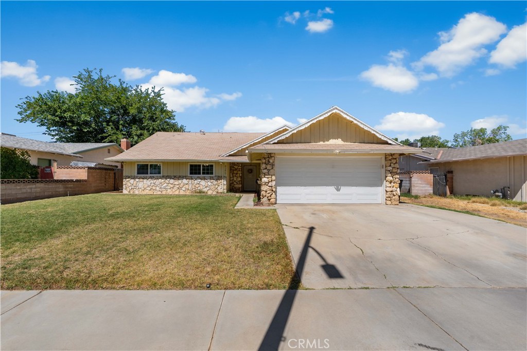 UPGRADES THROUGHOUT! This beautiful West Lancaster home offers 1,937 square feet of living space with 2 full baths and 3 bedrooms plus a HUGE bonus room that could easily be a 4th bedroom. Functional floorplan with two large living areas that share a GORGEOUS double sided brick fireplace. The kitchen has been nicely upgraded with granite countertops, tile backsplash, undermount stainless steel sink, light pendants and a reverse osmosis filtration system! The spacious primary retreat has it's own sitting area, two closets and a private bathroom. The hallway bath was recently remodeled in 2023 with a new vanity, LED backlit smart mirror, large tile shower with river rock accents and a rainfall shower head. Other features include laminate flooring, NEWER WINDOWS, water softener, ceiling fans and a 2 car attached garage with a BRAND NEW automatic opener. The backyard has a full length covered patio, block wall fencing, fruit trees and possible RV access. This is truly a MUST SEE home!