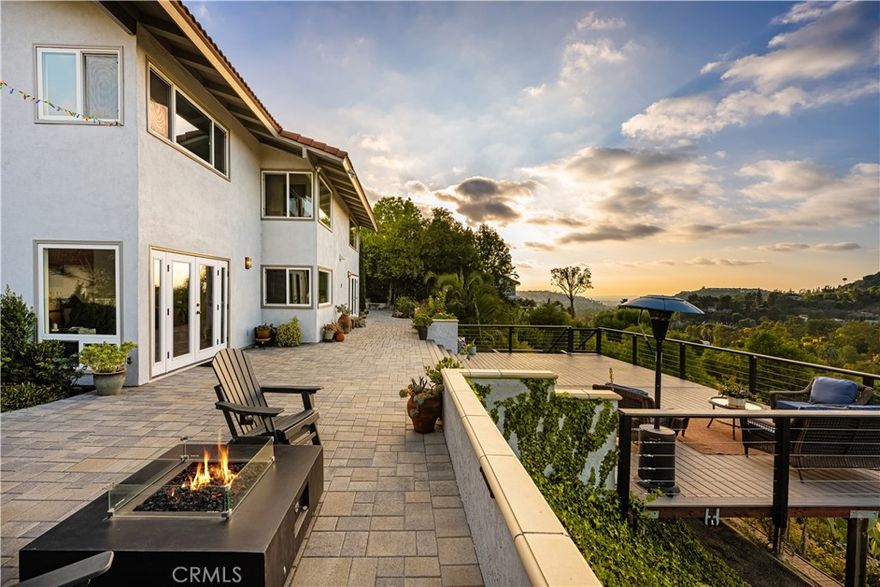 Fantastic opportunity to own this pool home that features unparalleled PANORAMIC VIEWS of sunsets and city lights from Catalina to Los Angeles. This turnkey home in North Tustin’s coveted Lemon Heights is a true personal sanctuary. This estate is private and serene, with lush landscape, custom outdoor decking, swimming pool, mature foliage and has ample spaces to entertain and enjoy the indoor/outdoor living that SoCal is known for.  The primary bedroom has a large retreat, and features loads of natural light and spa-like bathroom with a soaker tub with gorgeous views of the local hills and city lights. Prepare gourmet meals in large chef’s kitchen featuring top-of-the-line stainless steel appliances, custom cabinets and granite countertops with an eat at island. The home also features dual air conditioner units, a tankless water heater, hardwood flooring and a designer fireplace. Nearby is the Peter’s Canyon Regional Park with hiking, biking and horse trails. This estate is very private and offers unmatched tranquility and safety and is just 15-20 minutes to John Wayne Airport and only 10 minutes to Tustin Ranch Golf Course and the Tustin/Irvine Marketplace.  The home is located within the excellent Tustin Unified School District (Arroyo Elementary, Hewes Middle and Foothill High) and is close to shopping, dining, 5/55/22/57 freeways and 241/261 toll roads.