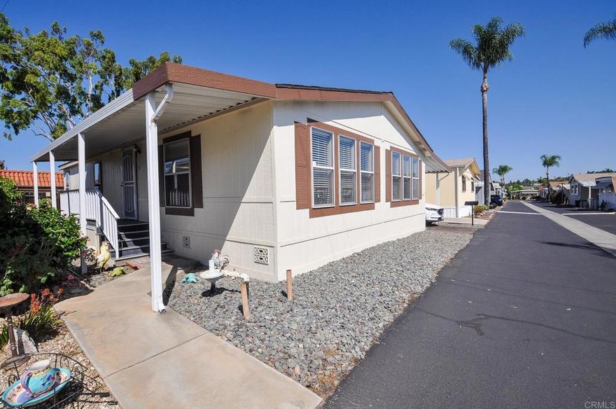 Beautifully renovated home located in one of East County’s most desirable and rare resident-owned, non-profit senior 55+ communities. This well-managed and impeccably maintained neighborhood offers resort-style amenities including a private dog park, pool, spa, clubhouse, and a vibrant calendar of social activities. With one of the lowest buy-ins in the area-just $6,000 (fully refundable upon sale) and a monthly space rent of only $615, this community is as affordable as it is welcoming. The home itself has been thoughtfully updated inside and out. Upgrades include a new roof (2024), new HVAC system with AC condenser (2023), new appliances and sink, new laminate flooring, and new Tuff shed. The spacious primary suite features an en-suite bathroom with a soaking tub and a generous walk-in closet. A built-in ramp in the carport area provides easy, convenient access to the front door. The private lot offers the perfect space to relax, BBQ, or entertain while enjoying peaceful sunsets. Additional highlights include a large 2-car covered driveway and convenient visitor parking directly across from the home. Great location has easy access to shopping, restaurants, and more.