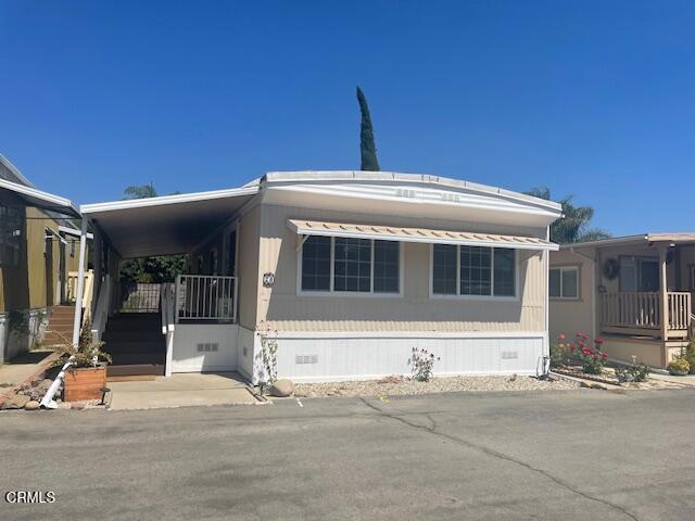 This beautiful home has been completely remodeled and updated throughout. Current owner has expanded and upgraded electrical service to support the addition of two mini-split units that serve the entire home with year-round comfort. The kitchen features new cabinets, quart counter tops with attractive decorative tile accents. All kitchen appliances are new or recently added as is the speed queen washer and dryer set that is included in the sale. Both bathrooms have also been remodeled with new cabinets and handsome tile shower and tub surround. There is also a tankless water heater that offers unlimited hot water on demand. Plenty of yard space is available should you wish to garden and even a mature guava tree. Newer manufactured homes limit yard space due to their size and style. A full length covered front deck with 'TREX' type decking provides for year around outdoor entertaining. Dual paned windows and handsome wood look laminate throughout complete this home just waiting for it's new owner.