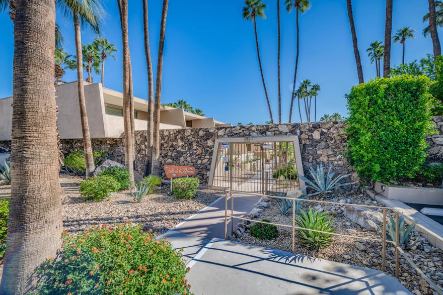 Rare Mid-Century Find -- Uptown Design District Modern Living.  Step into the Palm Springs lifestyle of the 1960s -- sleek lines, open spaces, and indoor-outdoor living at its best. This rare 2-bedroom, 2-bath residence is located within the iconic ''Villa de Las Palmas'', a gated, 24-unit Mid-Century Modern community built in 1962. Perfectly situated on West Via Lola, once affectionately known as ''Millionaire's Row,'' this address captures the timeless glamour of the Uptown Design District.  Inside, discover an airy living and dining space wrapped in dramatic floor-to-ceiling glass -- approximately 15 feet wide by 8 feet high -- framing postcard views of Mt. San Jacinto. The home's layout flows effortlessly to a spacious 15' x 19' entertaining balcony (approx. 285 sq. ft.), where cocktail hour meets sunset in true Palm Springs style.  All indoor and outdoor spaces of the condo are on the same level.  Beautifully renovated greenbelt and desertscape (2023) with year-round heated Pool, Spa and Fire/Water Feature ... all facing Mt. San Jacinto.  Don't forget the hard-to-find, assigned, underground garage parking space.  Steps from Ernest Coffee, Tailor Shop Craft Cocktail Bar, Hyphen Wine Shop, Saffron & John's restaurants.  Less than 1/4 mile to 849, Jake's, Cafe La Jefa, Workshop & Trio (which is a 3 minute walk). Stroll or bike through your exclusive Old Las Palmas neighborhood any day of the week. HOA allows 30-day or longer rentals.  Pets welcome.  Two renovated units recently sold for $870,000 each (2025). NOTE: Tax Records indicate every unit in this complex is only 1 Bedroom.  Ask your agent for photos of the adjacent condominium that was beautifully renovated a few years ago.  Transform Unit 7 into the ''Palm Springs Getaway'' of your dreams!