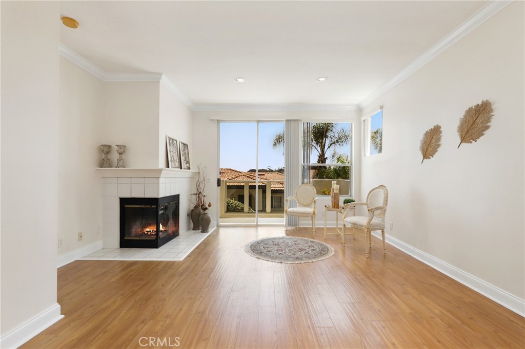 Welcome to this bright and airy 2-bedroom, 2-bath corner unit, perfectly situated just minutes from the beach. This charming home features laminated flooring throughout and a stylish kitchen with granite countertops. Enjoy partial views from the comfort of your living space and take advantage of resort-style amenities including a pool, spa, and gym. Located in a well-maintained community of La Vista with no Mello-Roos, this is coastal living at its best—convenient, comfortable, and move-in ready.