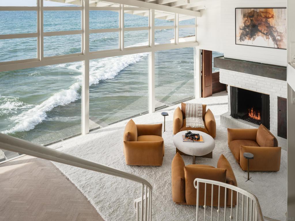 Kesling’s Glass House at Spindrift Own a piece of architectural history that has seen thoughtful updates over the years while preserving original charm. Situated on the pristine sands of La Jolla Shores, this extraordinary property offers a rare and exclusive estate on a sprawling 19,603 sqft lot featuring three independent structures capturing a coastal center stage vantage point. Designed by notable architect William Kesling, (recently rediscovered and credited for pioneering the transition from Streamline Moderne to International style in Southern California), the Lower house is driven by structural integrity and purpose. Showcased by LIFE magazine in 1947 the home displays a time period, appropriately on the beaches on La Jolla Shores with starlets and style, and uniquely captured by renowned architectural photographer Julius Shulman. LOWER HOUSE: The bedrooms are well appointed. There is a loft with a view, a private kitchen, outdoor decks, a bar, family room, and a dedicated office. On the lower level there is an intimate wine cellar, hang out space and private office. UPPER HOUSE: The upper residence showcases a modern retreat designed for functional indoor-outdoor living. Breathtaking views from all entertaining spaces, ocean-view decks, landscaped garden, pool, elevator, separate living room, and full kitchen create the ultimate setting for relaxation or hosting. Additional bedrooms offer sweeping views of the Pacific from The La Jolla Cove to Carlsbad. For added flexibility, a beautifully appointed guest house with unexpected views, a private yard and separate entrance sitting discreetly off the main driveway—ideal for extended stays or visiting guests. Parking is unparalleled, with a private driveway and TWO 2-car garages! Situated mere steps from The Marine Room and La Jolla Beach & Tennis Club, this landmark residence embodies sophistication, comfort, and unmatched access to La Jolla’s finest offerings. A once-in-a-lifetime opportunity to experience iconic coastal living!