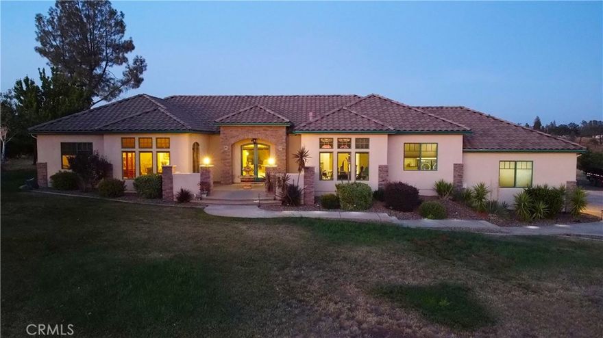 Prepare to be impressed with this Tuscan Beauty! Perfect location for this beautiful custom 3 bedroom plus office/Den, 3 bath quality home With SHOP! Situated on nearly 2 Acres in popular exclusive Blue Oaks Terrace gated community. Just minutes from Chico, just below the Town of Paradise. County zoned. With over 3,000 Sq. ft of Living space, The home features include a Desirable split bedroom floor plan. Lovely master bedroom and bath, featuring dual sinks, custom shower and separate garden bathtub. Kitchen offers dual ovens, lots of beautiful cabinetry, kitchen nook, center island, large formal dining room, formal living room and den. Beautiful Tuscan style 6 ft wide hallways with arched openings, 10 ft high ceilings, single story, tile roof, high quality windows and doors, Granite Counters, and travertine tiles. Home offers two separate HVAC units, only one is used for the majority of the house. In the afternoon the large back patio is shaded and cools down nicely for summer  get-togethers & BBQ's. A great house for entertaining. It's easy to enjoy the outdoor living including watching the wildlife roam in the back yard. Huge detached 1500 SQ FT 30'x50' Garage/Shop wired with 220V, and equiped with 2 garage doors. Excellent private water supply and septic system. Utilities: Underground Natural gas, electric and fiber optic cable. Please provide pre-qual letter