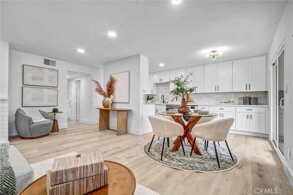 Nestled within the prestigious Quail Meadows community, this exquisitely renovated 2-bedroom, 2-bathroom condominium presents 772 square feet of refined living space. Located at 12-17562 Vandenberg Lane in Tustin's coveted Foothill High School district, this property showcases meticulous attention to detail throughout its complete transformation.
The residence features elegant light oak laminate flooring that flows seamlessly across the living spaces, complemented by energy-efficient dual-paned vinyl windows and doors. The gourmet kitchen serves as the home's centerpiece, boasting pristine white shaker cabinets with soft-close mechanisms, premium stainless steel appliances, and sophisticated quartz countertops. A striking porcelain tile backsplash and modern black hardware elevate the culinary experience, while a convenient washer-dryer combo adds practical functionality.
Both bedrooms offer ensuite bathrooms, creating private retreats with mirrored closet doors for enhanced space perception. The bathrooms have been thoughtfully reimagined with porcelain tile shower and bath enclosures, frameless shower doors, custom vanities, and coordinating black hardware and fixtures.
Climate control is seamlessly managed through central air and heating systems, ensuring year-round comfort. The unit provides pleasant views of the community pool, while residents enjoy access to well-maintained tennis courts.
This prime Tustin location offers exceptional convenience, with Columbus Tustin Park just steps away for outdoor recreation. Sprouts Farmers Market ensures easy grocery shopping, while proximity to Newport-17th transit station provides excellent connectivity. The nearby Foothill High School adds educational convenience to this already desirable neighborhood setting.