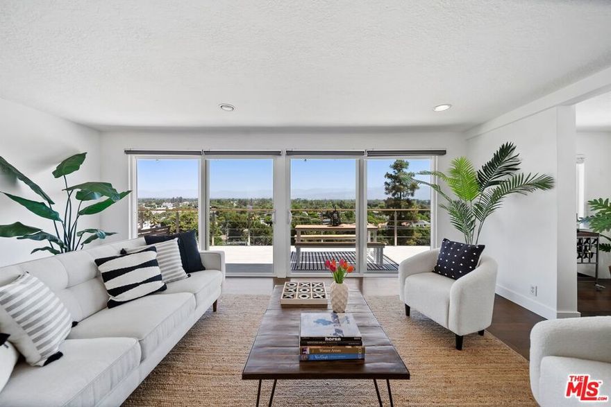 South of the Blvd, nestled in the hills of Studio City, this modern 3-bedroom, 3-bath sanctuary offers sweeping, unobstructed views of the valley and the glittering skyline beyond. As you descend the stairs to the main level, you are immediately embraced by privacy, space, and a sense of calm, wrapped in a canopy of mature trees that frame this hillside escape. The heart of the home unfolds in a spacious living room adorned with a cozy fireplace and an adjacent dining nook, perfect for intimate dinners or relaxed evenings with a view. Expansive sliding glass doors lead directly to a sprawling entertainment deck, a true showpiece for al fresco living. Watch the city lights shimmer beneath you as you sip wine under the stars or host vibrant gatherings that stretch long into the night. The updated kitchen is both functional and full of charm, featuring a gas stove, breakfast bar, and a whimsical swinging door that leads directly to a secluded patio designed for cool summer night dinners and fireside conversations. The master suite is a peaceful retreat with a private study, while the guest bedroom offers direct access to the deck and its breathtaking vistas. Descend once more to discover a jewel of this property. The 556 sq ft private guesthouse with a full kitchen, bath, living area, and bedroom. Whether used for visiting guests, a creative workspace, or your own personal haven, this lower-level suite offers both flexibility and seclusion. Lush landscaping and mature trees envelop the property, providing shade, serenity, and a rare sense of true privacy just minutes from the heart of the city. If you're seeking panoramic views, spacious indoor-outdoor living, and the luxury of your own hillside retreat, 11689 Picturesque Drive is a rare offering you won't want to miss. A short walk from the best bars, eateries and stores that Ventura Blvd has to offer in close proximity to some of the best public and private schools in LA.