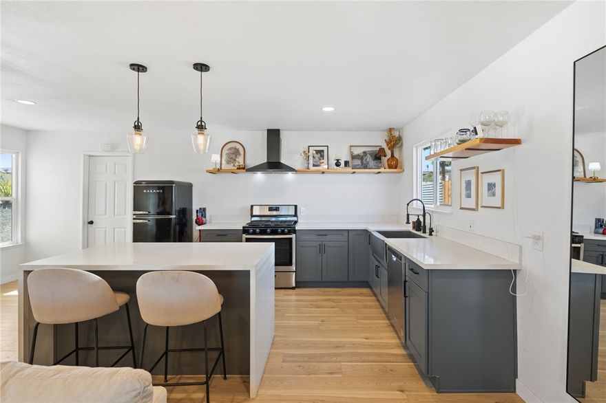 Whether you’re seeking a peaceful desert retreat or the perfect family home, discover the best of Twentynine Palms living at 73904 Playa Vista Drive, a beautifully remodeled and thoughtfully upgraded desert oasis. This 3-bedroom, 2-bathroom home spans 1,258 sq. ft. and is fully turnkey for its next owner. From the new laminate flooring and recessed lighting to the expanded sliding door off the living room, newer toilets, custom mirrors and lighting, every detail has been updated with quality and care. The open-concept kitchen showcases quartz countertops, a luxury waterfall island, and modern fixtures, including an oversized sink. Both bathrooms have been completely renovated with custom tile work and contemporary finishes. The seamless flow between the kitchen, living area, and back patio makes entertaining effortless, inside or out. Step outside to enjoy open desert views, enhanced privacy with a galvanized steel and wood fence, desert-inspired landscaping, and a custom paver wall surrounding the nearly half-acre lot adorned with towering palm trees. The spacious backyard offers the perfect setting for stargazing, relaxing in a hammock, or gathering around the fire pit. Modern comfort meets efficiency with central air and heat, managed by Google Nest, ensuring year-round comfort. Conveniently located near downtown Twentynine Palms, Tortoise Rock Casino, and just minutes from Joshua Tree National Park, this home embodies the desert lifestyle - stylish, serene, and truly unforgettable.