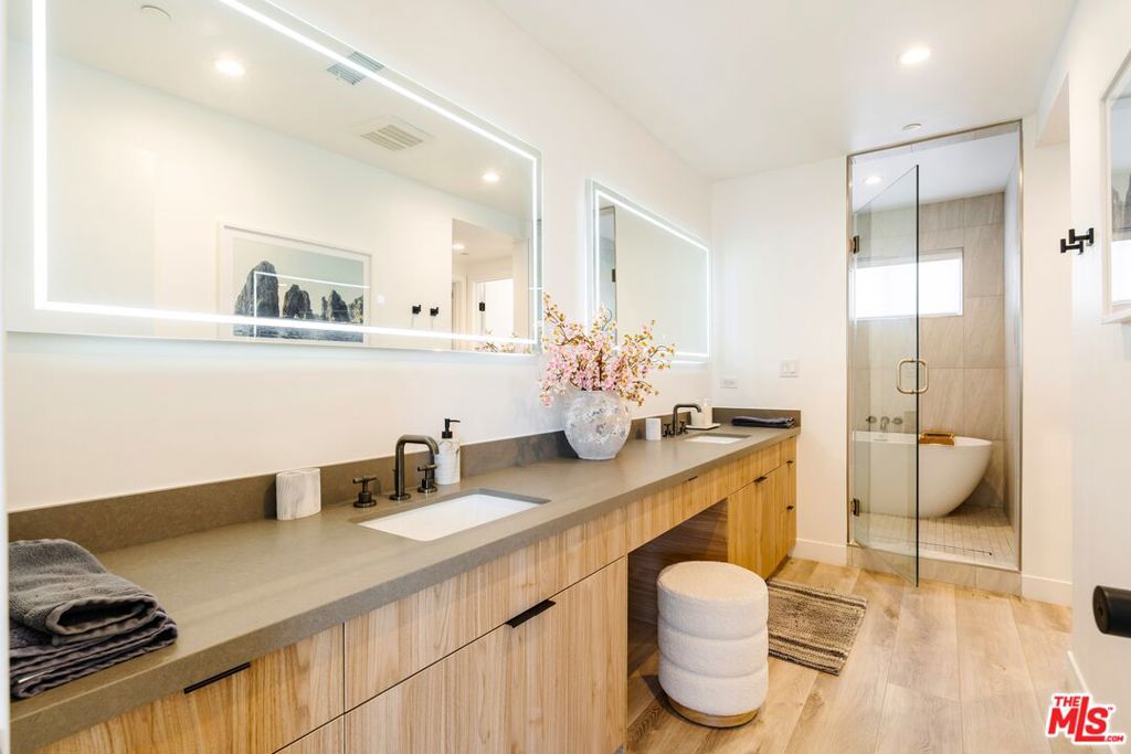 Welcome to your new home - a sleek, sunlit retreat in one of LA's most sought-after neighborhoods. This newer constructed 3-bedroom, 3.5-bath single family home blends smart design with luxurious comfort across approximately 2,000 square feet of thoughtfully crafted space with no shared walls. Step inside to soaring ceilings, clean lines, and a seamless open layout perfect for entertaining. The designer kitchen features quartz countertops, soft-close cabinetry, ample storage, elegant under cabinet lighting and high-end stainless steel appliances all opening to a bright living space with plenty of natural light. The primary suite is a true escape on its own floor, with a spa-inspired bathroom, including a large wet room, soaking tub, oversized dual vanity and walk-in closet that checks every box. Each of the 2 additional spacious bedrooms has its own en-suite bathroom and walk-in closet offering privacy, versatility and comfort. The primary suite leads to your own private rooftop deck which includes a flat screen television - an entertainer's dream with panoramic city views and space to dine, lounge, and unwind under the stars. 360 Views of fireworks on 4th of July. Additionally, this home offers a second patio, garage pre wired for 240V electric car charger, tri-zone HVAC, high-speed wired internet, laundry room, recessed and bathroom mirrors with LED lighting, a tankless water heater, and gated garage and entry. All of this just minutes from Playa Vista, Venice Beach, Mar Vista, Culver City, Marina del Rey, LAX, the beach and top-tier restaurants, shops, and parks.