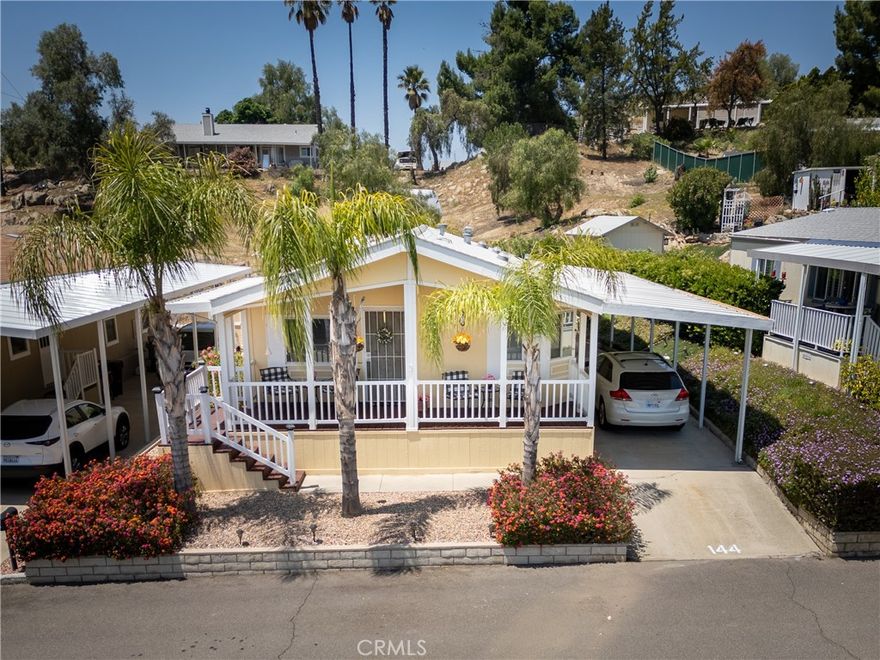 BUYERS DON'T WAIT! Seller just installed a new roof and reduce the price! Motivated Seller! Discover this charming and move-in-ready home featuring two spacious bedrooms and two bathrooms. Enjoy the bright sunny patio perfect for outdoor entertaining, leading into a welcoming living room with plenty of natural light. The modern kitchen boasts elegant wood floors, a large bay window, and a handy kitchen island, making meal preparation enjoyable. Adjacent to the kitchen is a dining area ideal for family gatherings. Conveniently located the hallway connects to the laundry room and back door, which is equipped with a chair lift for added accessibility. The private main suite offers a relaxing retreat with an attach bathroom featuring a separate tub and shower. BUYERS DON'T WAIT! The second bedroom provides comfortable space for family or guests. Step outside to a fully landscape backyard lush shrubs and greenery-your private outdoor oasis. The front yard is beautifully maintained, enhancing curb appeal. Recently professionally cleaned, including carpets, the home shines and is ready for its new owners. The side door has an electric lift, making accessibility a breeze, but the original stairs are available if you prefer. The backyard features a large shed for extra storage, and the carport will easily fit two vehicles. Perfectly situated in a friendly community with easy access to local amenities, parks and highways. This property offers comfort, convenience, and exceptional value. Schedule your tour today and experience all that this wonderful home has to offer.