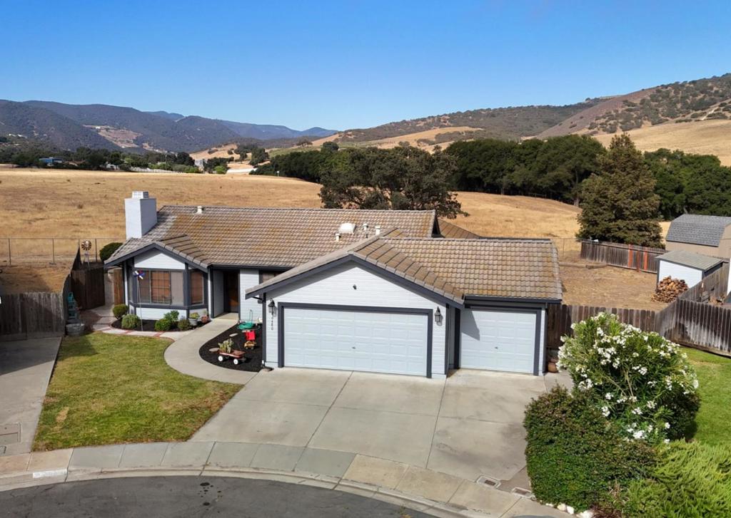 Single-level home in Pine Meadow Estates on a rare and desirable lot that stretches front to back with no rear neighbors just open fields, sweeping views, and the occasional cow visitor. This flexible 4 bedroom floorplan includes a 3-car drive-through garage and nearly 9,000 SF of outdoor space. The 4th bedroom can serve as a home office or formal dining room. Inside you'll find two generous living areas: a formal living room with fireplace and slate entry, and a vaulted family room and an updated kitchen with breakfast bar and reverse osmosis system. Additional features include fresh interior and exterior paint, water softener, skylight and a convenient indoor laundry room. The backyard is made for outdoor living with a pergola-covered hot tub, paver patio and a stunning fireplace, perfect for relaxing or entertaining. A full-size storage shed completes this spacious and serene property. Lovely neighborhood offering easy country living with parks, a sports court, and open space to enjoy the outdoors. Privacy, space, and peaceful living all come together here. Don't miss your chance to call this one home.