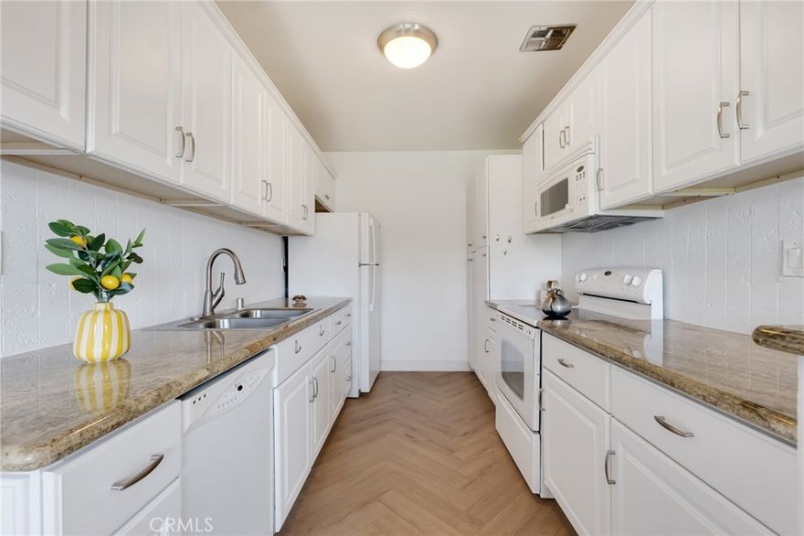 Welcome to this beautifully maintained and light-filled 1-bedroom, 1-bathroom condo located in the heart of Encino. Offering 731 sq ft of comfortable living space, this charming unit features an open and inviting floor plan with laminate flooring, central AC, and ample storage throughout. The spacious living room opens to a private balcony overlooking the peaceful, landscaped courtyard—perfect for relaxing or enjoying your morning coffee.

The galley-style kitchen is equipped with granite countertops, clean white cabinetry and well-kept appliances. The generously sized bedroom offers a deep walk-in closet, while the full bathroom is clean and well-appointed. This well- maintained community offers resort-style amenities including a sparkling pool, spa, gym, and secure entry. One covered parking spot and extra storage are included. Don’t miss this rare opportunity to own a stylish top-floor corner unit in one of Encino’s most desirable neighborhoods!