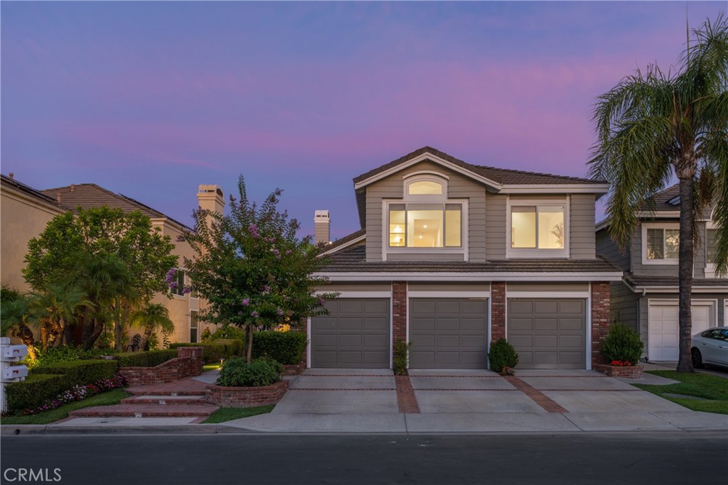 Welcome to 6 Rainier, an elegantly remodeled home of nearly 3,000 square feet in the exclusive guard-gated community of Dove Canyon. With four bedrooms and three bathrooms, this home is ideally positioned on a flat cul-de-sac, blending privacy, comfort, and refined design. The entry opens to two-story ceilings and an abundance of natural light. Wide-plank wood floors extend through the main level, creating a warm and cohesive flow. The formal living room showcases a marble-faced fireplace and recessed lighting, while the dining room is adorned with wainscoting, crown molding, and a statement chandelier. The redesigned kitchen features quartz countertops, soft-close cabinetry, gold fixtures, and professional-grade Viking appliances. A large island with counter seating pairs with a breakfast nook, creating the perfect space for gatherings. A statement range with pot filler, wine refrigerator, and reverse osmosis system elevate both style and function. The kitchen opens seamlessly to the family room, anchored by a fireplace with custom millwork and sliding doors to the backyard. A main-level bedroom with walk-in closet sits near a full bath enhanced with wood paneling, gold hardware, and a frameless glass shower. The updated laundry room offers custom cabinetry and counters. Upstairs, the primary suite boasts vaulted ceilings, a designer chandelier and black accent details. The spa-inspired primary bath has dual vanities, a soaking tub, walk-in shower, and wood paneling reaching the ceiling, all accessed through sliding barn doors. A large walk-in closet completes the retreat. Two additional oversized bedrooms share a Jack-and-Jill bath with quartz counters, shiplap accents, and black fixtures. The oversized bonus room impresses with wood-beamed ceilings, wall paneling, a beverage bar, and panoramic Saddleback Mountain views. The backyard is designed for both relaxation and entertaining, with a generous lawn, expansive paver patio, and raised garden beds. A three-car garage offers builtin storage and gym space, while owned solar panels, a whole-house water filtration system, and softener add valuable upgrades. Residents of Dove Canyon enjoy exclusive amenities including a pool, tennis courts, parks, and scenic walking/hiking trails.