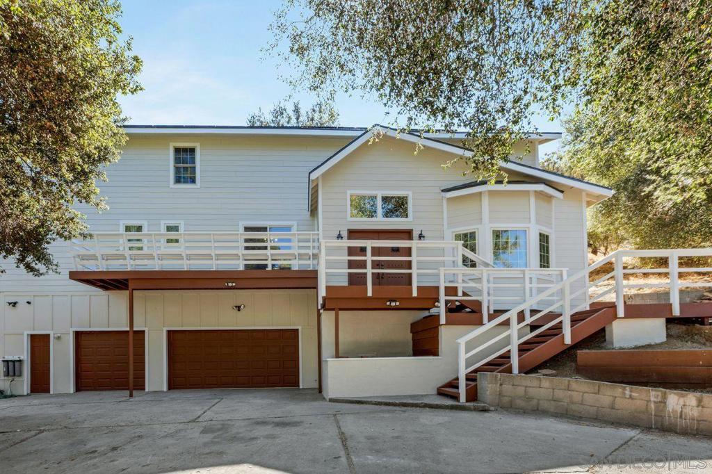 Welcome to your serene mountain escape in the heart of Pine Valley! This 4-bedroom, 3.5-bath custom home with a spacious bonus room offers nearly 2,900 sq ft of versatile living space on a wooded, private lot at approx. 3,700 ft elevation. Rustic charm meets modern comfort with thoughtful upgrades throughout. Enjoy soaring ceilings, new dual-pane sealed windows designed to block heat, new window frames, and a generous bonus room; perfect for a home office, gym, or game room. The primary suite includes a private nursery, offering convenience and comfort for growing families. Recent exterior improvements include a brand new roof, solar panels, new garage doors, and new fiber cement siding with fresh exterior paint, a rare find in this peaceful mountain community. The kitchen is both functional and spacious, offering ample storage and a wet pantry ideal for entertaining. Inside, you’ll also find new flooring in the living room, stairs, and upstairs. The home features two fireplaces; one wood-burning stove and one traditional fireplace creating a warm and inviting ambiance throughout. The oversized 3-car garage offers high ceilings and generous space for storage or hobbies. The sloped lot provides privacy and scenic forest views from every angle. Whether you're looking for a full-time residence or a weekend getaway, this one-of-a-kind property offers the perfect blend of comfort, charm, and lifestyle in Pine Valley. 2.75% VA assumable loan Discover the peaceful beauty of mountain living at 8141 Pine Blvd in the charming community of Pine Valley. Nestled at approximately 3,700 feet elevation, this spacious 4-bedroom, 3.5-bath custom home offers nearly 2,900 sq ft of thoughtfully designed living space on a private, wooded lot with scenic views, mature trees, and a serene natural backdrop. This one-of-a-kind property blends rustic charm with smart, modern upgrades—making it ideal as a full-time residence or tranquil weekend escape. Inside, you'll find soaring ceilings and new dual-pane sealed windows designed to block heat and improve efficiency, along with all new window frames. A spacious bonus room provides the flexibility to function as a home office, gym, playroom, or guest space. Recent exterior upgrades add tremendous value and curb appeal, including: • Brand new roof • Solar panels • New fiber cement siding • Fresh exterior paint • New garage doors Inside, the kitchen is both functional and spacious—perfect for cooking, entertaining, or everyday use. It features ample cabinet storage and a wet pantry for convenience and prep space. Recent interior upgrades include new flooring in the living room, on the stairs, and throughout the upstairs living area. The home offers two fireplaces—a cozy wood-burning stove in one living space and a traditional fireplace in another—providing warmth and ambiance during Pine Valley’s cooler seasons. The layout includes a total of 4 bedrooms and 3.5 bathrooms, offering plenty of space for family, guests, or multi-generational living. The oversized 3-car garage is ideal for those needing extra room for hobbies, vehicles, workshop space, or storage. The garage features high ceilings and direct access to the home, making it both practical and secure. Situated on a sloped lot, the home enjoys a heightened sense of privacy and stunning forest views from multiple vantage points. There is ample opportunity to create outdoor living areas, garden spaces, or enjoy the peaceful surroundings just as they are. Pine Valley is a close-knit community surrounded by the Cleveland National Forest, offering access to hiking trails, nature walks, horseback riding, and seasonal weather with a touch of snow in the winter months. Just under an hour from downtown San Diego, you can enjoy the best of both worlds—quiet mountain life with access to coastal amenities. This home is a rare opportunity to own a move-in ready property in one of East County’s most sought-after rural settings. With modern improvem...