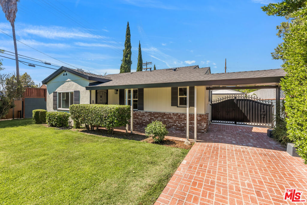 Welcome to an incredible opportunity to own a nicely updated California Bungalow in the heart of Valley Village, a neighborhood prized for its picturesque tree-lined streets, tight-knit community, and top-rated Colfax Charter School. Privately located behind a fence with tall hedges and a motorized gated entry, the brick driveway and charming front porch beckon you to the front door. Enter into a spacious and light-filled living room with a cozy fireplace, perfect for relaxing or entertaining. The living room flows seamlessly into the dining room, which opens to a thoughtfully upgraded kitchen that features new cabinetry, sleek black granite countertops, and brand new high-end Bosch appliances. A breakfast bar connects the kitchen and dining space, creating an ideal setting for casual dining and conversation. The main residence includes two generously sized bedrooms and an updated bathroom, complete with a new tub, a separate glass-enclosed shower, and modern cabinetry, as well as a dedicated laundry area. Throughout the home, enjoy newly installed luxury Pergo plank flooring, recessed lighting, new vinyl windows, and a new HVAC system. Additional upgrades include a new roof, copper plumbing, updated electrical including a 200-amp panel, and a fully integrated sprinkler and drip irrigation system. A major highlight of this property is the detached garage that has been converted into a guesthouse, approximately 450 square feet (not included in the listed square footage). This flexible space features a large living area, private kitchenette, bathroom, generous walk-in closet and a new wall-mounted AC split unit. Its perfect for use as a additional living space, a home office, guest suite or studio. Set on a spacious lot, the property boasts generous front and rear grassy yards. There is an additional gated entry at the rear of the property allowing ingress and egress from the adjacent alley. The combination of mature landscaping, tall fencing, and a secure gate offers both privacy and a peaceful retreat from the city. Don't miss this amazing value and opportunity to own a turn-key home with versatile living options in one of the most desirable pockets of Valley Village.