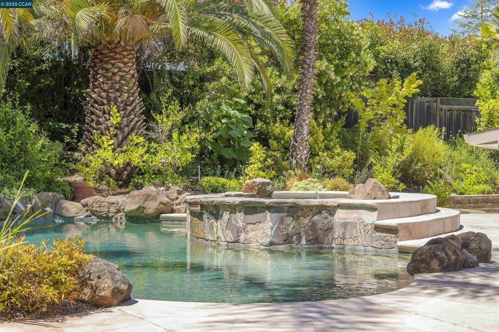 Welcome to 14 Dublin Court, a beautifully updated home located at the end of a quiet cul-de-sac in Pleasant Hill’s desirable Shannon Hills neighborhood. Set on a spacious 1/3-acre lot, this home features a resort-style backyard with pool, spa, covered patio, raised garden beds, multiple storage sheds, and total privacy—ideal for entertaining or everyday relaxation. Inside, you'll find fresh interior paint, hardwood and bamboo flooring, updated fixtures, and an excellent layout with a formal living room, large family room, dining area, eat-in kitchen, inside laundry, and four spacious bedrooms. The kitchen features granite counters, stainless steel appliances, and refreshed cabinets with new hardware. Bathrooms have been updated with new finishes and the primary suite includes a walk-in closet. Energy-efficient features include owned solar, Tesla Powerwall, two new heat pumps, and a high-efficiency PebbleTec pool with in-floor self-cleaning system. Built-in speakers inside and out. Minutes to Lafayette, Walnut Creek, BART, shopping, and top-rated Pleasant Hill schools. Open Houses 6/28 & 6/29 1-4 and 7/1 11-1.