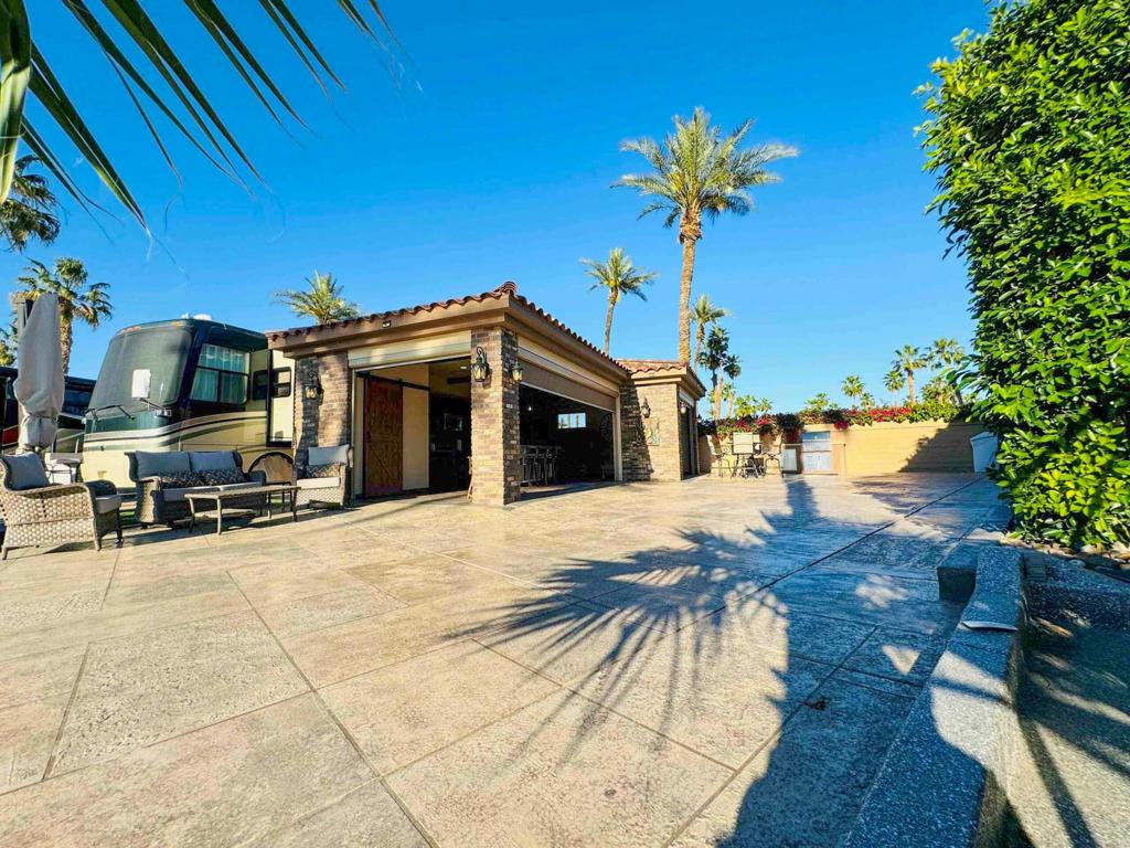 Experience the perfect blend of outdoor living and indoor comfort on this exceptional luxury RV lot featuring a fully furnished, 600 sq. ft. Casita. Enjoy breathtaking sunsets and mountain views from your private retreat, enhanced by three fully automatic wall screens that seamlessly blend indoor and outdoor spaces. The spacious driveway, finished with a two-tone epoxy overlay and resealed curbs, offers ample room for a 45-foot RV, a vehicle, and a golf cart. A plumbed water softener for your coach adds convenience, while the turnkey furnishings, including patio furniture, dishware, and glasses, ensure a move-in-ready experience.The beautifully designed Casita includes custom cabinetry, a stainless steel fridge, dishwasher, stove/oven, garbage disposal, and granite counters, with an 8-foot island and four new upholstered stools at its heart. The living area features a leather sectional sofa, a full-wall brick fireplace, a 65' mounted TV with a Samsung soundbar, two ceiling fans, and recessed LED lighting throughout. Climate control is provided by a Lennox Mini-Split HVAC unit. Situated on an oversized, pie-shaped lot, the property includes a Lynx Sedona BBQ area with granite countertops, a dog run, and extra storage space. This Casita also offers an excellent short-term rental opportunity, currently generating premium income and rented until the end of March. Whether as your personal sanctuary or a high-income rental property, this lot delivers unparalleled luxury and functionality.‍Outdoor Resort Indio is a Class A only RV resort in Indio, CA.