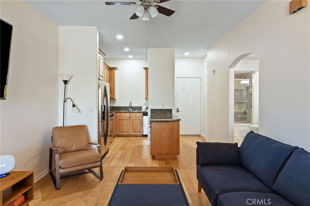 Welcome to your peaceful retreat at Breakwater Village, one of Redondo Beach’s most desirable 55+ communities. This beautifully updated top-floor penthouse condo perfectly blends comfort, style, and convenience, ideal for those seeking a vibrant yet low-maintenance lifestyle in a coastal setting. Step inside and immediately feel the warmth of natural light streaming through the windows, illuminating the elegant wood flooring and spacious open-concept layout that creates a true sense of home. The kitchen is both stylish and functional, featuring granite countertops, stainless steel appliances, abundant cabinetry, and a center island with a breakfast bar, perfect for morning coffee or casual meals with friends. The generous living and dining area flows seamlessly onto a private east-facing balcony through sliding glass doors. From here, enjoy sweeping views of city lights, snowcapped mountains, and even Downtown Los Angeles on a clear day. It’s an ideal spot to start your morning or relax in the evening with a book or a glass of wine. The primary bedroom offers tranquility and comfort, complete with a custom-designed closet that maximizes storage and organization. Just down the hall, the modern full bathroom serves as a spa-like sanctuary, boasting a sleek vanity with ample counter space and storage, contemporary lighting, a beautifully tiled tub and shower combo with glass enclosure.
A stackable washer and dryer are discreetly tucked away inside the unit for maximum convenience, accompanied by an additional storage closet for all your essentials. This secure, gated building offers garage parking with a dedicated space, a private storage unit, and elevator access directly to your floor. The community amenities are exceptional: a heated pool, outdoor lounge area with a fireplace, BBQ stations, a clubhouse with a full kitchen and dining area, pool table, private theater room, and a fully equipped fitness center. Residents also enjoy a year-round calendar of social events that foster a true sense of community. Location is everything, and Breakwater Village delivers. You are just minutes from the beach, Galleria Mall, shopping, restaurants, medical offices, and freeway access, putting everything you need within easy reach. Whether you are downsizing, investing in a second home by the coast, relocating a loved one, or planning your next chapter, this turn-key condo offers a warm, welcoming space to call home.