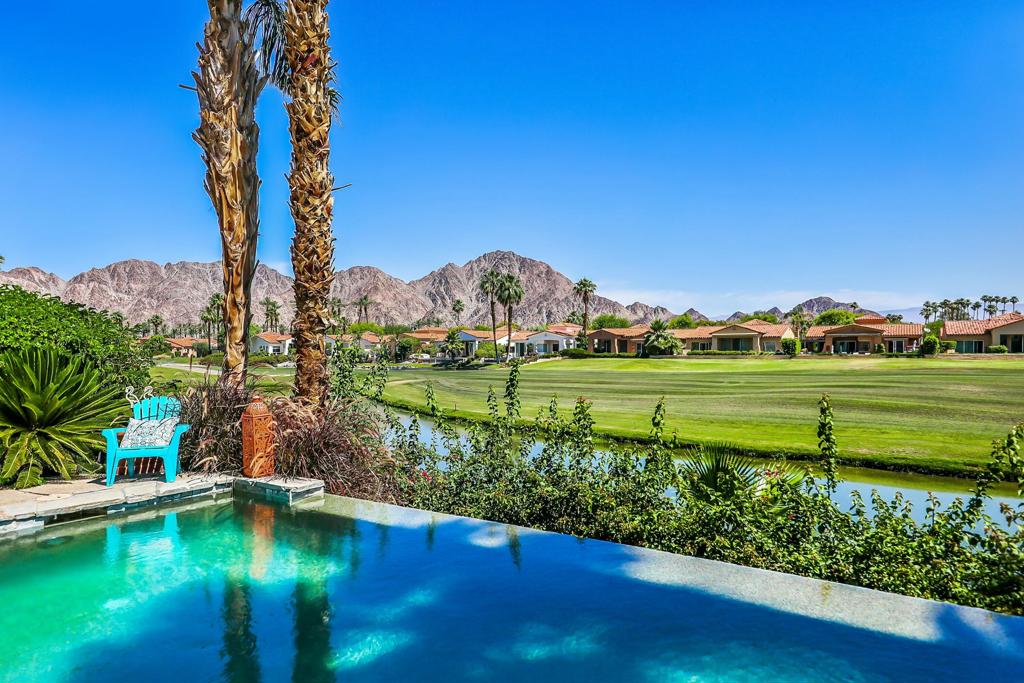 NOW AVAILABLE ALL MONTHS. Gorgeous residence nestled alongside the lush fairways of the renowned Haciendas community, perched on the prestigious resort course, The Dunes. Offering the quintessential blend of luxury and convenience, this gated enclave is just moments from the charm of Old Town La Quinta, with the clubhouse and hotel of the La Quinta Resort mere steps away, as well as the esteemed La Quinta Country Club across the street--a prime locale indeed. This beautiful home boasts two bedrooms within the main house, complemented by a two-room casita complete with a convenient kitchenette. Granite adorns the kitchen and baths, while stainless steel appliances grace the well-appointed kitchen. The great room boasts a captivating sit-down bar, affording panoramic views of the golf course and tranquil lake beyond .However, it's the outdoor oasis that truly captivates, where an elevated infinity pool seemingly cascades into the serene waters of the adjacent lake--a sight to behold. Completing this alfresco haven is a built-in BBQ area, perfect for entertaining amidst the picturesque backdrop of the golf course. This residence epitomizes resort-style living at its finest, offering a sublime blend of luxury, comfort, and unparalleled surroundings.