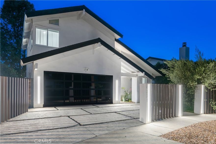 This stunning 4-bedroom, 3.5-bathroom two-story home has been completely reimagined, offering modern luxury at the end of a peaceful cul-de-sac in Encino. From the moment you arrive, custom double-entry doors welcome you into soaring two-story ceilings, an elegant staircase, and a spacious, light-filled open-concept formal living area. The space flows seamlessly into the formal dining room, complete with a cozy fireplace and a sleek, double-sided wet bar—perfect for entertaining. The oversized gourmet kitchen is a chef’s dream, combining striking form and practical function.  It boasts clean lines, dramatic quartz countertops and backsplash, abundant counter and storage space, and a large center island. The kitchen flows effortlessly into an informal living space.  Downstairs, a versatile bonus room provides flexibility for use as a private office, guest room, media room, playroom, studio, or third living area. From the kitchen, step outside to a private backyard oasis with a grassy lawn and a covered patio—perfect for grilling, entertaining, or enjoying weekends with friends and family. Upstairs, the spacious primary suite boasts vaulted ceilings and two generous closets, including a walk-in. The luxurious en-suite bathroom is appointed with dual vanities and a walk-in waterfall shower. Three additional bedrooms and 2 fully updated bathrooms are also located on the upper level. Two of the bedrooms open onto a sprawling 366-square-foot private balcony—an ideal retreat for morning coffee or quiet evenings. The larger of the 2 balcony-access bedrooms features an extra-large custom-built closet for added storage. Located just minutes from schools, Lake Balboa Golf Course and Recreation Area, the Sepulveda Basin bike path, a popular dog park, Trader Joe’s, and numerous shopping and dining options. Enjoy easy access to Ventura Blvd, the Orange Line, and the 101 and 405 Freeways.