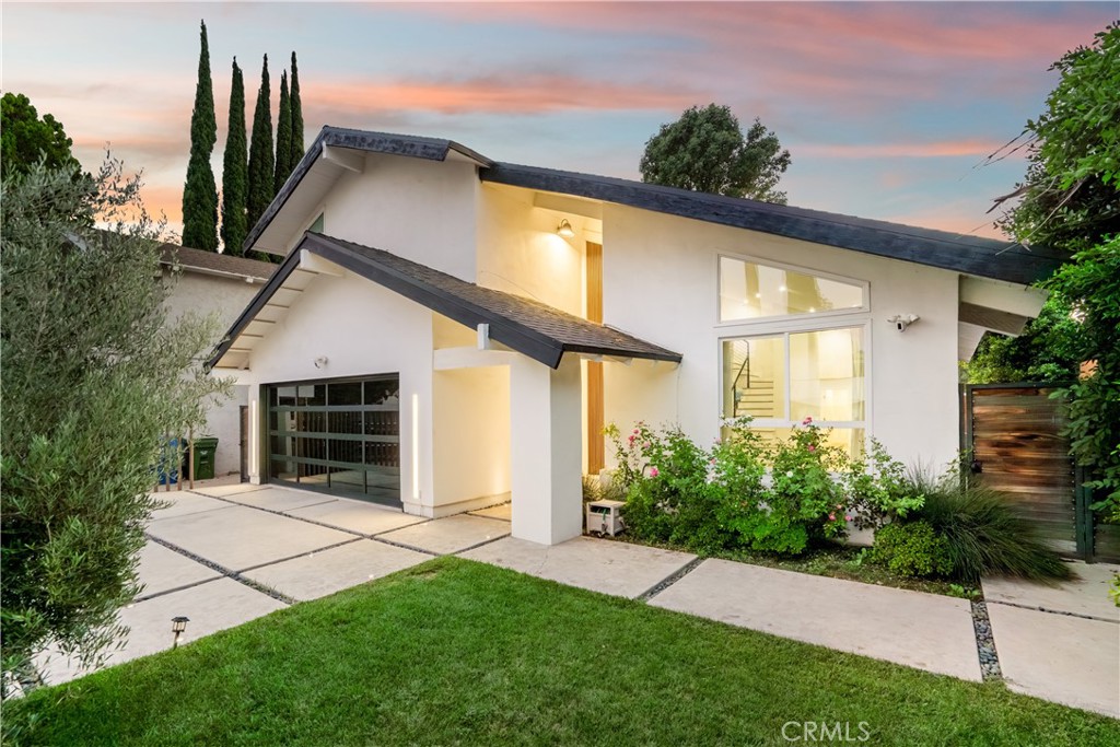 This stunning 4-bedroom, 3.5-bathroom two-story home has been completely reimagined, offering modern luxury at the end of a peaceful cul-de-sac in Encino. From the moment you arrive, custom double-entry doors welcome you into soaring two-story ceilings, an elegant staircase, and a spacious, light-filled open-concept formal living area. The space flows seamlessly into the formal dining room, complete with a cozy fireplace and a sleek, double-sided wet bar—perfect for entertaining. The oversized gourmet kitchen is a chef’s dream, combining striking form and practical function. It boasts clean lines, dramatic quartz countertops and backsplash, abundant counter and storage space, and a large center island. The kitchen flows effortlessly into an informal living space. Downstairs, a versatile bonus room provides flexibility for use as a private office, guest room, media room, playroom, studio, or third living area. From the kitchen, step outside to a private backyard oasis with a grassy lawn and a covered patio—perfect for grilling, entertaining, or enjoying weekends with friends and family. Upstairs, the spacious primary suite boasts vaulted ceilings and two generous closets, including a walk-in. The luxurious en-suite bathroom is appointed with dual vanities and a walk-in waterfall shower. Three additional bedrooms and 2 fully updated bathrooms are also located on the upper level. Two of the bedrooms open onto a sprawling 366-square-foot private balcony—an ideal retreat for morning coffee or quiet evenings. The larger of the 2 balcony-access bedrooms features an extra-large custom-built closet for added storage. Located just minutes from schools, Lake Balboa Golf Course and Recreation Area, the Sepulveda Basin bike path, a popular dog park, Trader Joe’s, and numerous shopping and dining options. Enjoy easy access to Ventura Blvd, the Orange Line, and the 101 and 405 Freeways.