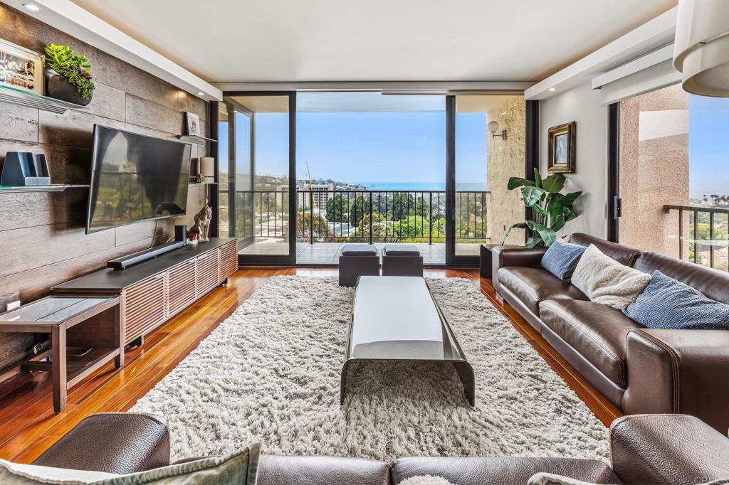 Oceanfront living reaches new heights in this stunning end-corner unit at Shore Tower, one of La Jolla’s most iconic high-rises. Perched on the 8th floor, Unit 805 offers sweeping panoramic views of the Pacific Ocean, La Jolla’s hillsides, and vibrant sunsets through expansive floor-to-ceiling sliding glass doors. This 2-bedroom, 2-bath residence blends luxury and comfort with a prime location just moments from La Jolla Shores Beach. Step inside to an open-concept floorplan bathed in natural light. The chef’s kitchen features waterfall quartz countertops, custom cabinetry, and smart stainless steel appliances. The spacious primary suite includes a walk-in closet, dual vanities, and a spa-style tiled shower. High-end finishes continue throughout with recessed LED lighting, motorized window shades, central HVAC, luxury vinyl or hardwood flooring, and ample storage. Shore Tower offers full-service, resort-style amenities. Residents enjoy a heated pool and spa, fitness center, sauna, tennis courts, and a lounge with a bar and kitchen. Two guest suites are available for overnight visitors. The HOA covers high-speed internet (500 Mbps), cable with HBO, water, sewer, trash, termite control, on-site management, full-time maintenance, exterior upkeep, and limited fire and earthquake insurance—providing exceptional value and ease of ownership. This iconic 14-story community is ideally located near everything La Jolla has to offer. Walk to the beach, La Jolla Village, fine dining, boutiques, UCSD, Scripps, Birch Aquarium, and more. With easy access to the UTC district and nearby freeways, this is the perfect full-time residence or lock-and-leave second home. Unit 805 at Shore Tower delivers the best of coastal luxury living—unmatched views, refined interiors, and an unbeatable La Jolla location.