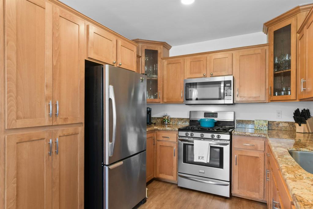 Welcome to this spacious upper-level condo, featuring 2-Bed/2-Bath. The kitchen features granite countertops and custom cabinets. The living room is super cozy with a fireplace, and you can step right out onto your private balcony to relax with a cup of coffee or tea. Inside, you'll find beautiful laminate flooring and upgraded windows that let in tons of natural light. Both bathrooms have been completely remodeled, giving them a fresh, modern feel. Laundry is conveniently located in the closet, complete with a side-by-side washer and dryer. You'll get one garage parking spot and two extra community spots—a huge bonus! The community itself is a resort-style retreat, complete with a pool, spa, and a recreation room. And the location, you're just a quick hop from the 805 freeway, putting you minutes away from excellent shopping and dining options. This condo is move-in ready and waiting for you!