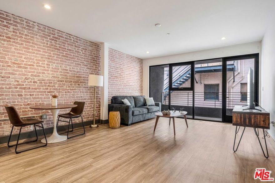 Experience elevated downtown living at The Piano Lofts, located at 932 South Hill Street in the heart of DTLA's vibrant South Park district. This fully furnished 2-bed/1-bath residence blends industrial design with modern comfort, featuring soaring ceilings, polished concrete or hardwood floors, and expansive windows that fill the home with natural light. The spacious open layout creates a seamless flow between living, dining, and kitchen areas, ideal for both relaxing and entertaining. The contemporary kitchen is equipped with stainless steel appliances, sleek cabinetry, a microwave, a dishwasher, and a full-size refrigerator. A private balcony offers the perfect spot to enjoy city views and fresh air. Convenience abounds with an in-unit washer and dryer, stylish furnishings, and thoughtful design details throughout. The bedroom provides generous closet space and abundant natural light, while the modern bathroom includes upgraded finishes and designer fixtures. Every element has been curated for a comfortable, turn-key lifestyle. Located moments from LA Live, Crypto.com Arena, Whole Foods, and some of the city's best dining, shopping, and entertainment, The Piano Lofts offer the ultimate downtown experience. This is more than a homeit's a lifestyle defined by creativity, energy, and modern luxury.