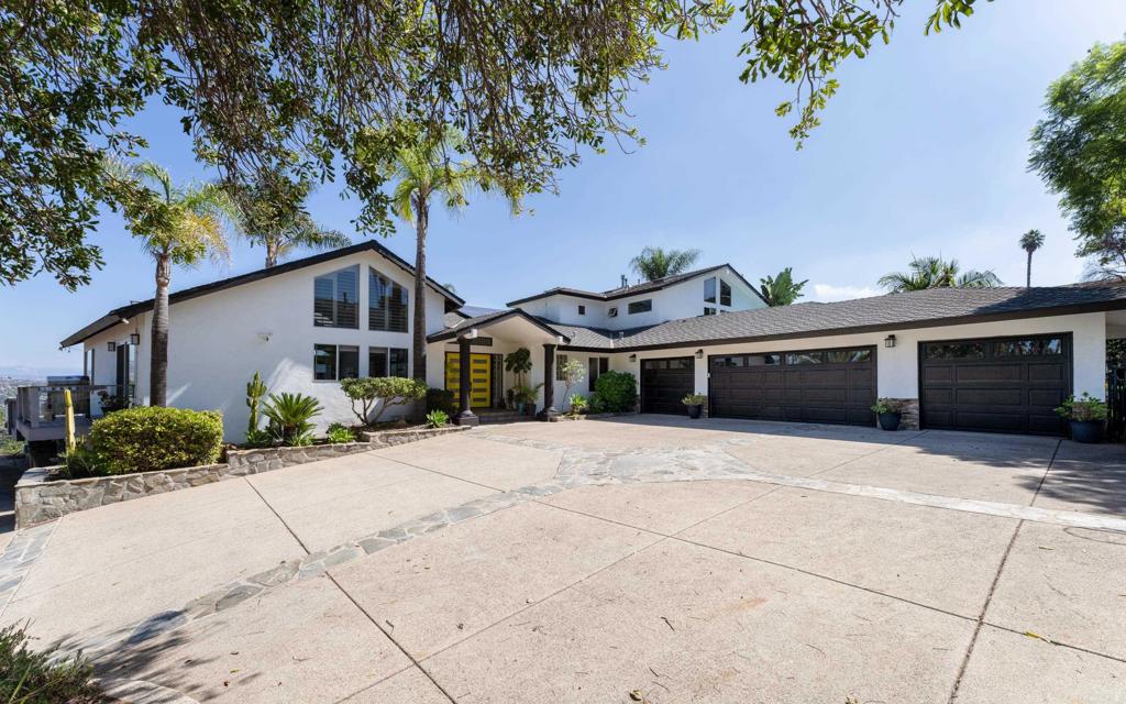 Absolute STUNNER in Mount Helix / Horizon Hills! This private contemporary California-style home is gorgeous inside and out, showcasing 180-degree panoramic views. Modern finishes throughout, including stainless steel appliances, stone counters, travertine & luxury vinyl flooring, custom light fixtures, vaulted ceilings, multiple skylights, and two gas fireplaces. The entire second floor primary suite is the perfect retreat, with floor to ceiling windows and private balcony overlooking pool and amazing mountain views. Massive spa-like ensuite bathroom with a huge custom walk-in closet, a secondary closet, tons of storage and its own HVAC. An attached large studio/granny flat/ADU (currently renting for $1500/mo.) includes a private exterior entry, kitchen, bathroom and walk-in closet. This beautiful, gated estate, just shy of an acre, is a fully fenced corner lot with spacious artificial grass area, koi pond, multiple decks, outdoor kitchen, fruit trees, RV parking, and a large in ground heated pool with waterfalls. In addition, there is an oversized attached 4-car garage, 40 solar panels and dual zoned main floor HVAC.