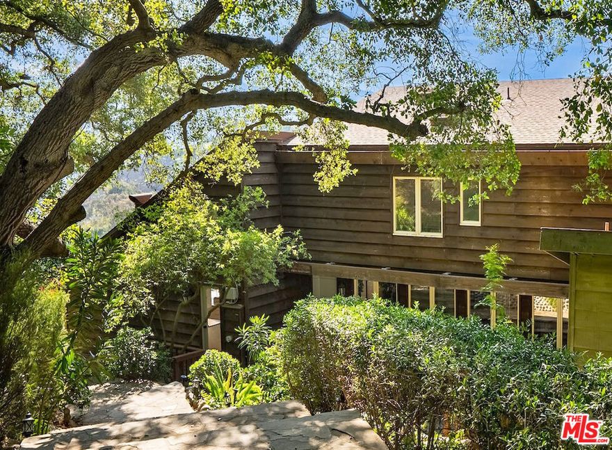 Perched atop a private road on one of Topanga's most coveted streets, 21338 Colina Drive offers breathtaking southern canyon views and effortless access to scenic park trails. This spacious 4-bedroom, 3-bathroom main home boasts an open-concept living room with soaring vaulted ceilings, rich hardwood floors, and a dramatic wall of glass that showcases expansive canyon vistas. The heart of the home is the true chef's kitchen, equipped with top-of-the-line appliances, ideal for entertaining or preparing intimate meals. The luxurious primary suite features a walk-in closet and a serene soaking tub for ultimate relaxation. Two additional bedrooms offer comfort and versatility, while a spacious family room functions perfectly as a second primary suite. Additionally, a cozy den makes an ideal home office, creative space, or reading nook. A private entrance leads to a charming 1-bedroom, 1-bathroom studio guesthouse with a kitchenette, perfect for studio for guests, extended family, or an office.. The home is encircled by expansive decks, offering the perfect setting to relax, dine, or entertain while taking in the captivating canyon views. With its prime Topanga location, spacious floor plan, flexible living spaces, and exceptional outdoor areas, this remarkable home is available for move-in starting April 15.