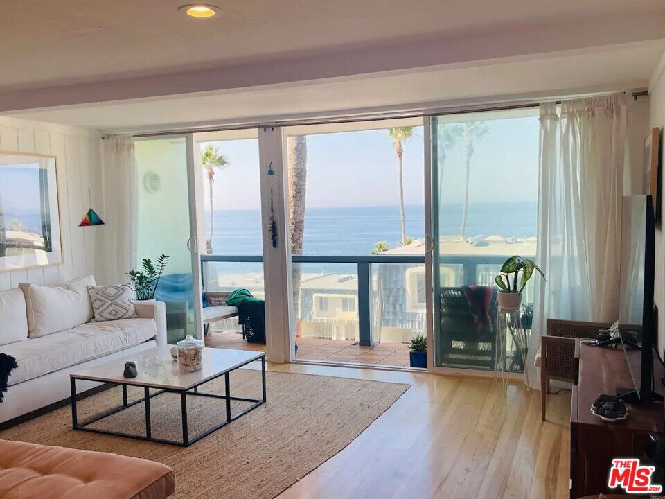 Experience the best of coastal living in this bright and airy 2 bed + 2 bath condo with mesmerizing ocean views, located inside the gated Malibu Bay Club community. This thoughtfully updated residence features two newly renovated bathrooms, a refreshed kitchen, and an ocean-view deck perfect for enjoying morning coffee at sunrise or evening sunsets over the Pacific. The primary suite offers stunning ocean views and a private en-suite bath. The second bedroom is conveniently located near the second full bath. Additional amenities include a private laundry room in the carport area and two covered parking spaces.The Malibu Bay Club offers direct beach access, a renowned surf spot, and resort-style amenities including a heated pool and spa. This home may be purchased fully furnished for immediate enjoyment. Just a 10-minute drive to Trancas Country Market with dining, retail, and conveniences including Kristy's Village Caf, Malibu Brewing Company, Starbucks, Vintage Grocers, and more.