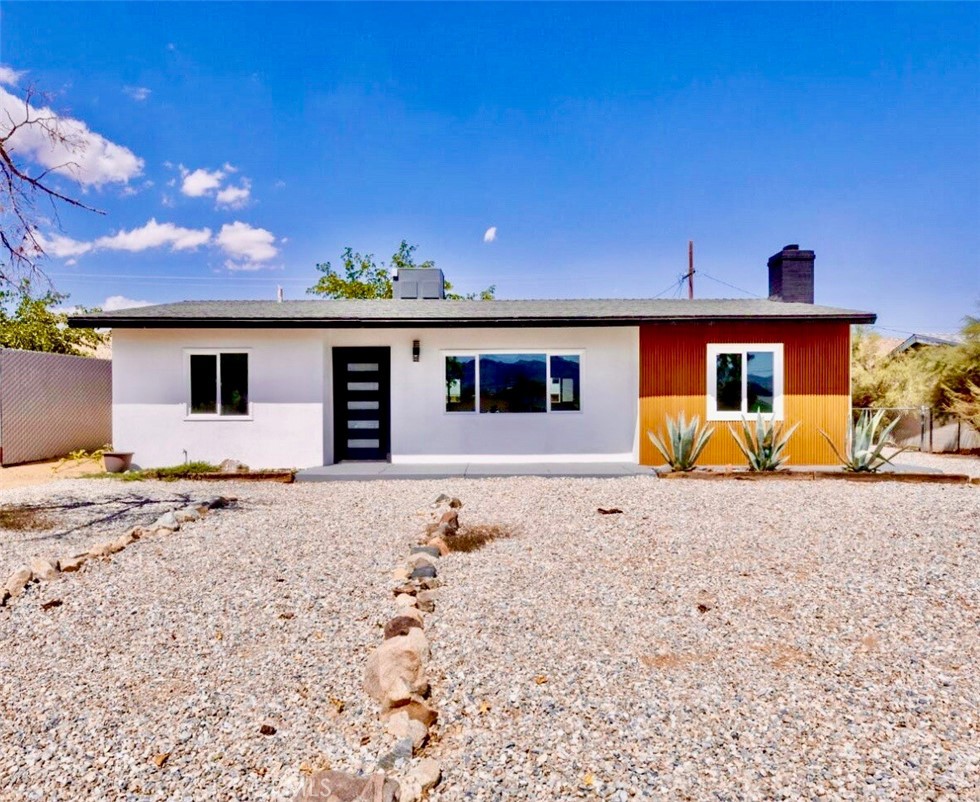Beautifully upgraded 3 bed, 2 bath home with stunning desert views and natural landscaping. Recent upgrades include a modern kitchen, new flooring, updated bathrooms, and fresh paint. Spacious fenced front and backyard with a detached garage that may offer ADU potential (buyer to verify). Just minutes from Downtown Joshua Tree, the National Park Visitor Center, Farmers Market, and local dining. Perfect as a primary residence, vacation home, or investment property this desert gem is move-in ready and priced to sell!