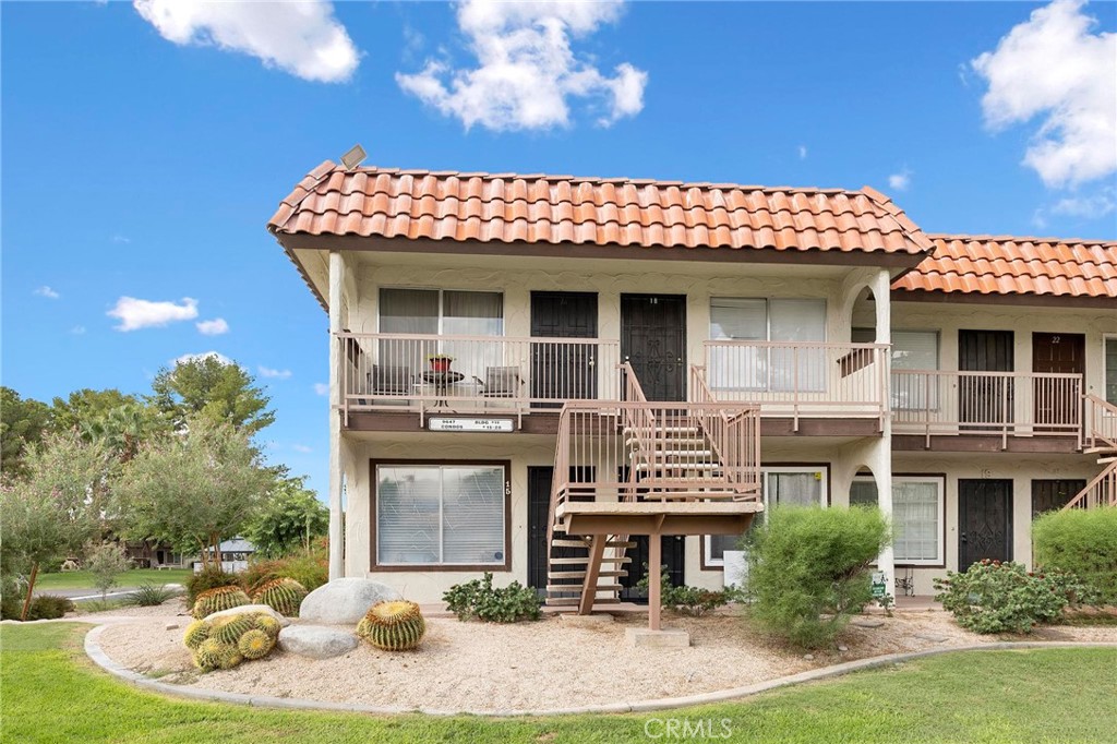 Welcome to your charming one-bedroom, one-bathroom retreat in the heart of Desert Hot Springs. Nestled within a tranquil country club community, this second story condo offers comfort, style, and convenience with sweeping golf course views and resort-inspired amenities. Inside, you’ll find a light-filled living space with fresh paint and modern laminate flooring that create a warm, inviting atmosphere. The open dining area is ideal for morning coffee or intimate meals, while the thoughtfully designed kitchen features crisp white appliances, sleek quartz countertops, and plenty of room for preparing your favorite dishes. The spacious bedroom provides a peaceful escape, perfect for both relaxation and everyday living. The bathroom boasts a walk-in shower, single-sink vanity, and tasteful finishes. Step outside to enjoy all the community has to offer, including a golf course, sparkling pool, clubhouse area, and fitness center. For added convenience, you’ll also have access to shared laundry facilities. Spend quiet mornings on your front porch with a good book, or simply take in the serene surroundings. Pets are welcome!