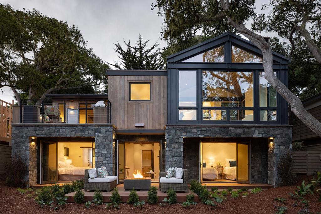Tucked in the heart of Carmel-by-the-Sea, "The Treehouse" presents a newly constructed residence of exceptional quality and sophisticated design. This soft contemporary home, a collaboration by Thomas Bateman Hood, Vance Killen Interiors, and Wayfinder Development, offers three bedrooms, three and a half baths, and a family room within its 2,020 square feet on a 4,991 square foot lot. Enjoy seamless indoor-outdoor living with expansive ipe decks on both levels from every bedroom. Inside, discover radiant heat, exquisite quartzite and cesarstone countertops, custom cabinetry, and professional-grade Thermador appliances. The exterior cohesively blends stone, steel, and clear cedar siding. The property also features two fire pits, an outdoor kitchen, and beautifully curated landscaping. Enhanced seclusion and privacy are integrated with a newly installed privacy wall, elegant window coverings, and trees gracing the landscape. Thoughtfully designed with energy efficiency and smart home technology throughout, including an induction cooktop and Energy Recovery Ventilator. Ideally located, "The Treehouse" is a five-minute stroll to the charming town center and a ten-minute walk to Carmel Beach.