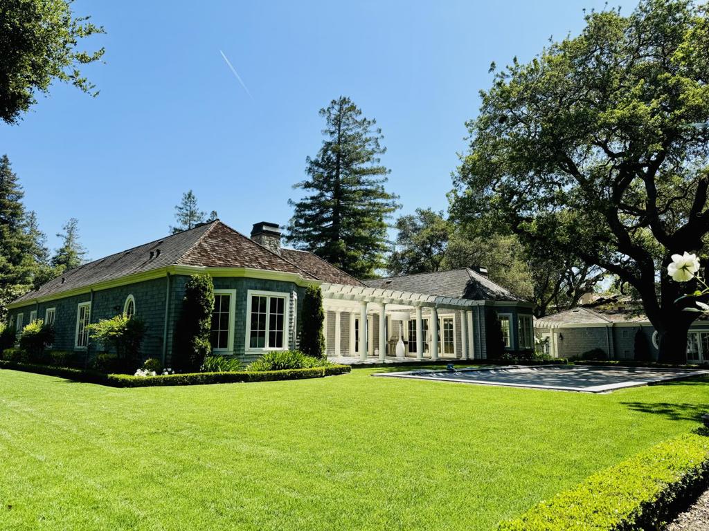 Discover the elegance of 187 James Avenue, Atherton, a prestigious single-level estate in the esteemed Lindenwood neighborhood. Built in 2012 by Tapia Construction and designed by Bob Glazier, this home blends traditional design with modern luxury. It features towering tray ceilings, crisp white millwork, and a neutral color palette. Offering four bedroom suites, two half baths, and a chefs kitchen with state-of-the-art appliances and an oversized island, it caters to both comfort and entertaining. The open floor plan and expansive windows fill the home with natural light, enhancing the warm hardwood floors throughout. An exquisite 1-bedroom guesthouse, a three-car detached garage, a pool, and a back terrace with a fireplace and trellis add to the home's appeal. Landscaped gardens create a private oasis around the pool. Advanced security systems ensure peace of mind, and proximity to prestigious Menlo Park schools offers excellent educational opportunities. Set on nearly an acre, this home promises privacy and exclusivity.