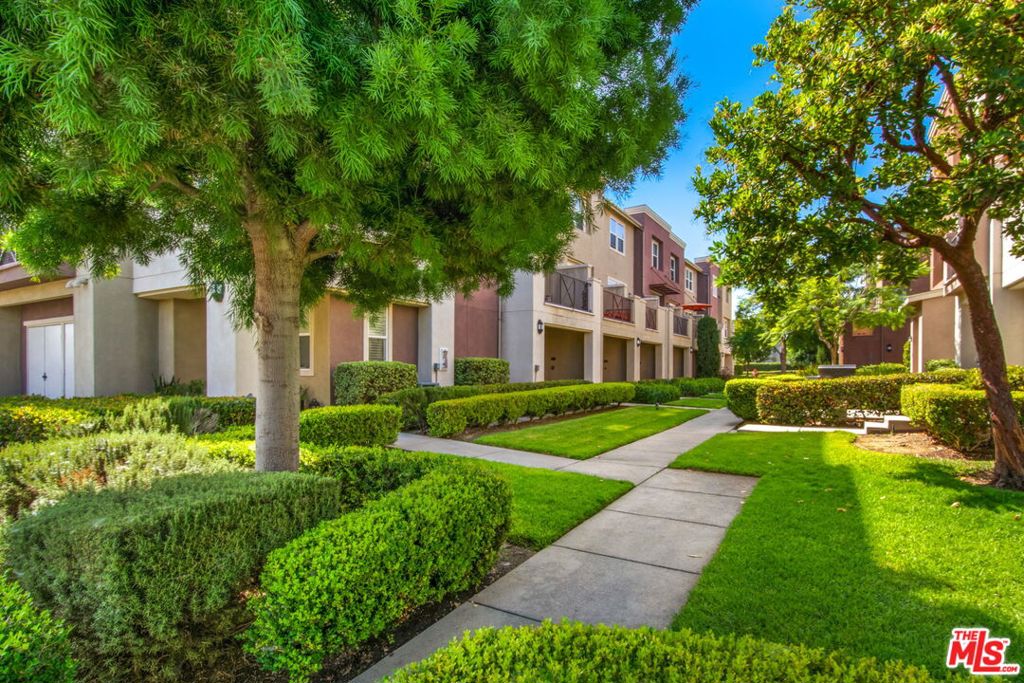 Spacious 3-Bedroom, 3-Bathroom FHA-Approved Townhome in Desirable Willow Walk Community. Welcome to one of the largest and most well-appointed condo-style townhomes in the gated Willow Walk community. Boasting 1,660 sq. ft of living space, this FHA-approved three-bedroom, three-bathroom home offers a functional layout, modern upgrades, and a two-car attached garage. Main Level Highlights: Convenient bedroom and full bathroom on the main floor, ideal for guests, multi-generational living, or a home office. Bright and airy living room with direct access to a private balcony, perfect for relaxing or entertaining. Open-concept kitchen featuring a breakfast bar, stainless steel appliances (stove, refrigerator, dishwasher, microwave), and ample cabinetry. In-unit washer and dryer included for ultimate convenience. Central air and heat for year-round comfort. Upper Level Retreats: Spacious primary suite with two closets and an en-suite bathroom. A second upstairs en-suite bedroom, perfect for family members or roommates. Recent Upgrades (January 2025): New water heater, New toilets, New garbage disposal. Community Features: Located within the secure and family-friendly Willow Walk gated community in Compton, residents enjoy lush green spaces and walking paths. Well-maintained common areas, Children's playground, BBQ grill areas perfect for gatherings. This move-in-ready townhome blends space, comfort, and convenience in a thriving community. Don't miss your chance to call it home! Call the Listing Agent for a showing. Furniture excluded.