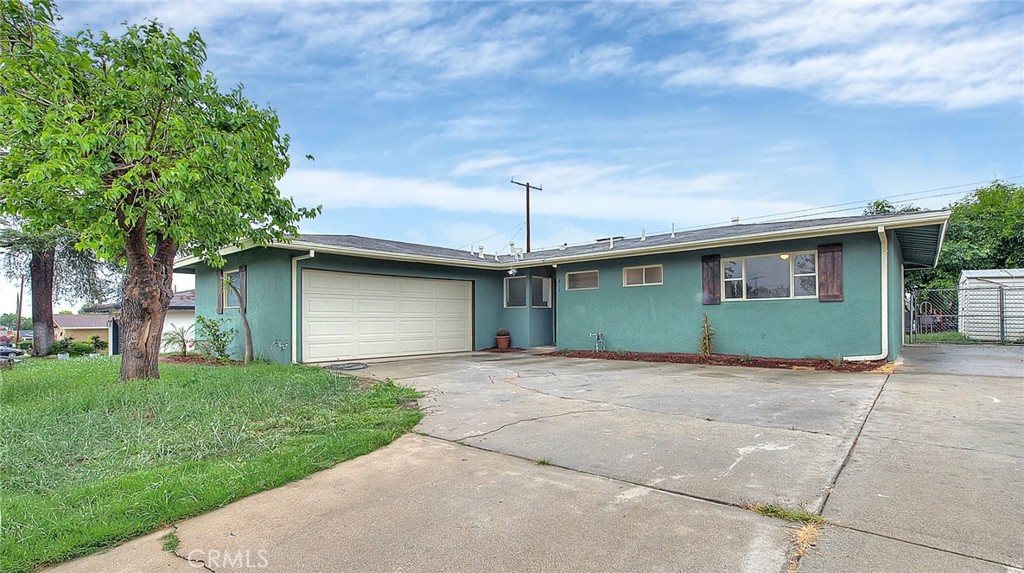 South Redlands 3 bed starter on large lot in a quiet neighborhood! A spacious driveway awaits you with RV parking included. Enter the house to the cozy living room with a brick fireplace and the fourth bedroom was opened up to the living room for extra space. (easily converted back into the fourth bedroom if needed). A functional corner kitchen featuring new cabinets, contemporary stainless steel appliances. Down the hall leads you to multiple bedrooms, a fully renovated full bath, and the primary suite, featuring a private 3/4 bath. The backyard is open and feels airy being able to view the school yard. A full two car garage has hookups for laundry, there are also ceiling fans in the bedrooms. Prime location in South Redlands steps from every activity your small town heart desires, including popular neighborhood markets, shopping, schools, hospital and minutes from all the commuting options, amenities, and excursions Southern California has to offer. Come see this one!